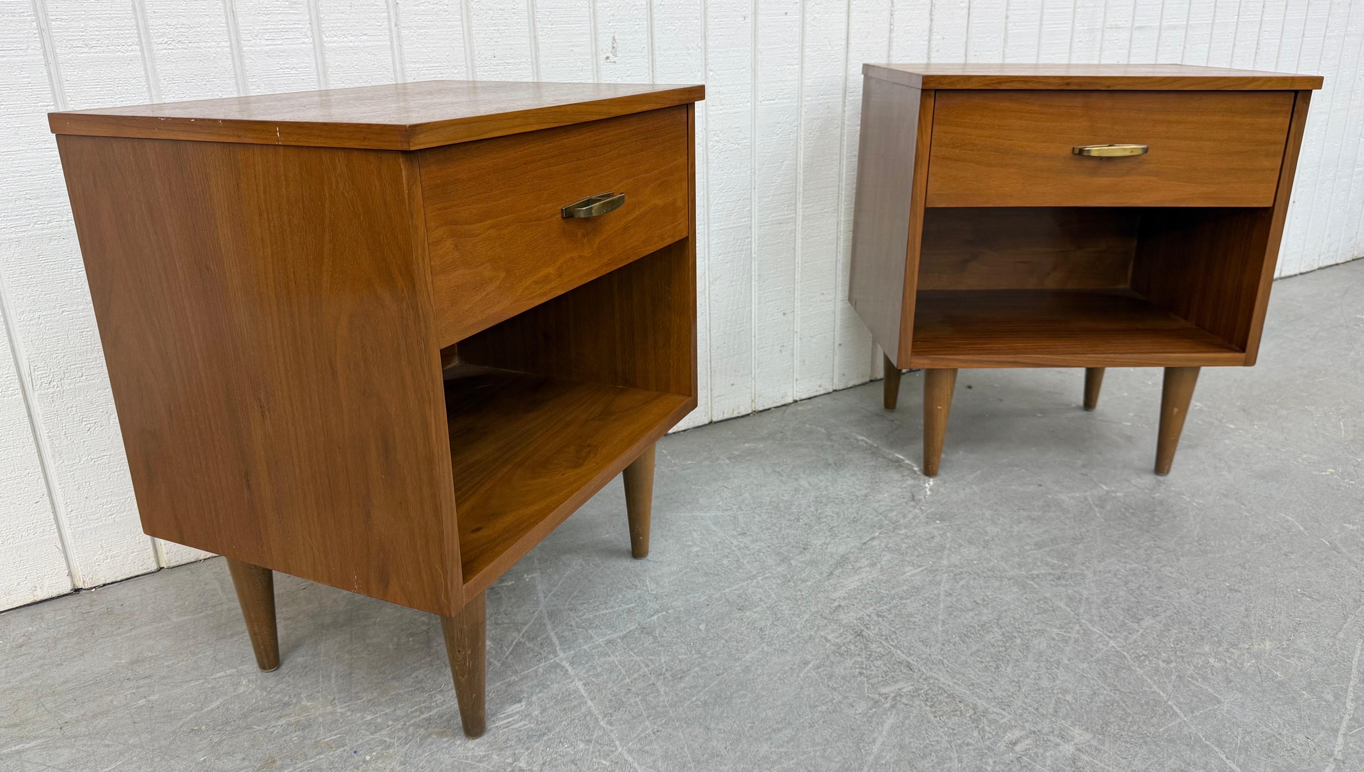 This listing is for a pair of Mid-Century Modern Walnut Nightstands. Featuring a straight line design, single drawer with brass hardware, open storage space at the bottom, modern legs, and a beautiful walnut finish. This is an exceptional