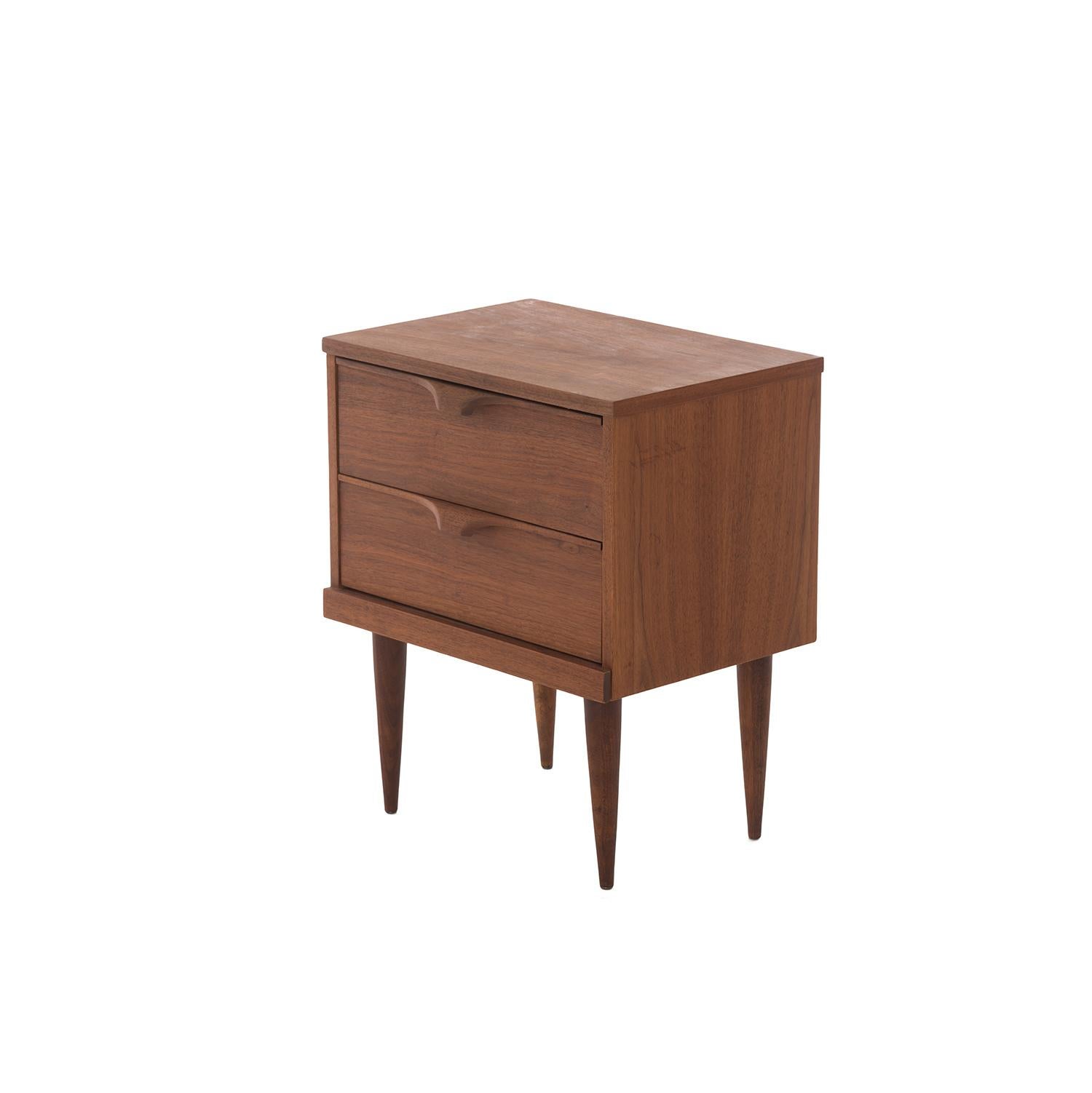 This midcentury walnut occasional chest has two deep drawers for storing anything you need. Solid carved wood finger pulls add a simple modern flair.

Professional, skilled furniture restoration is an integral part of what we do every day. Our
