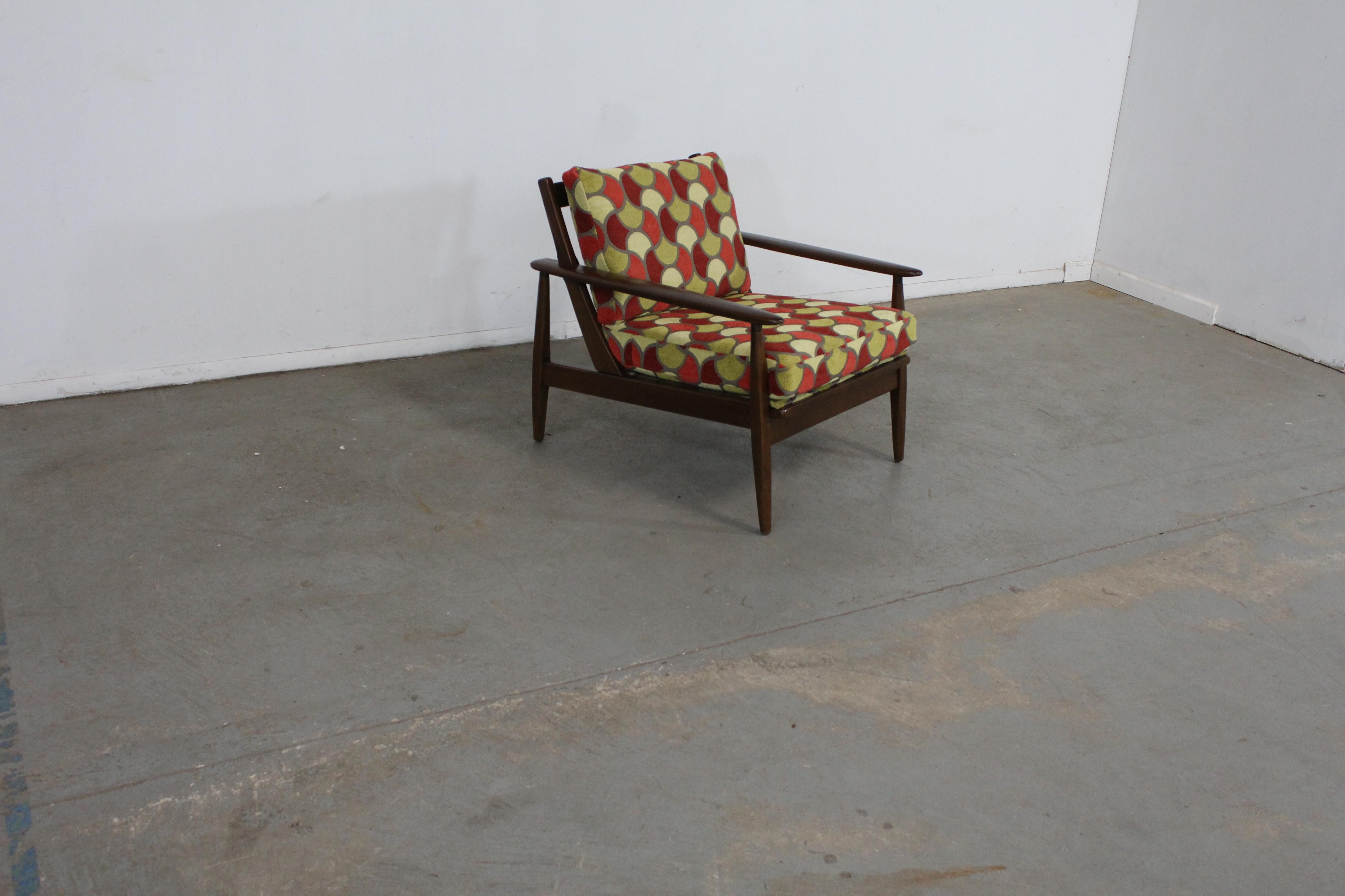Mid-Century Modern walnut open arm rocking / lounge chair.

Offered is a Mid-Century Modern open arm rocking / lounge chair. This piece is made of walnut and has been restores and  upholstered with textured retro geometric fabric. Ready for any