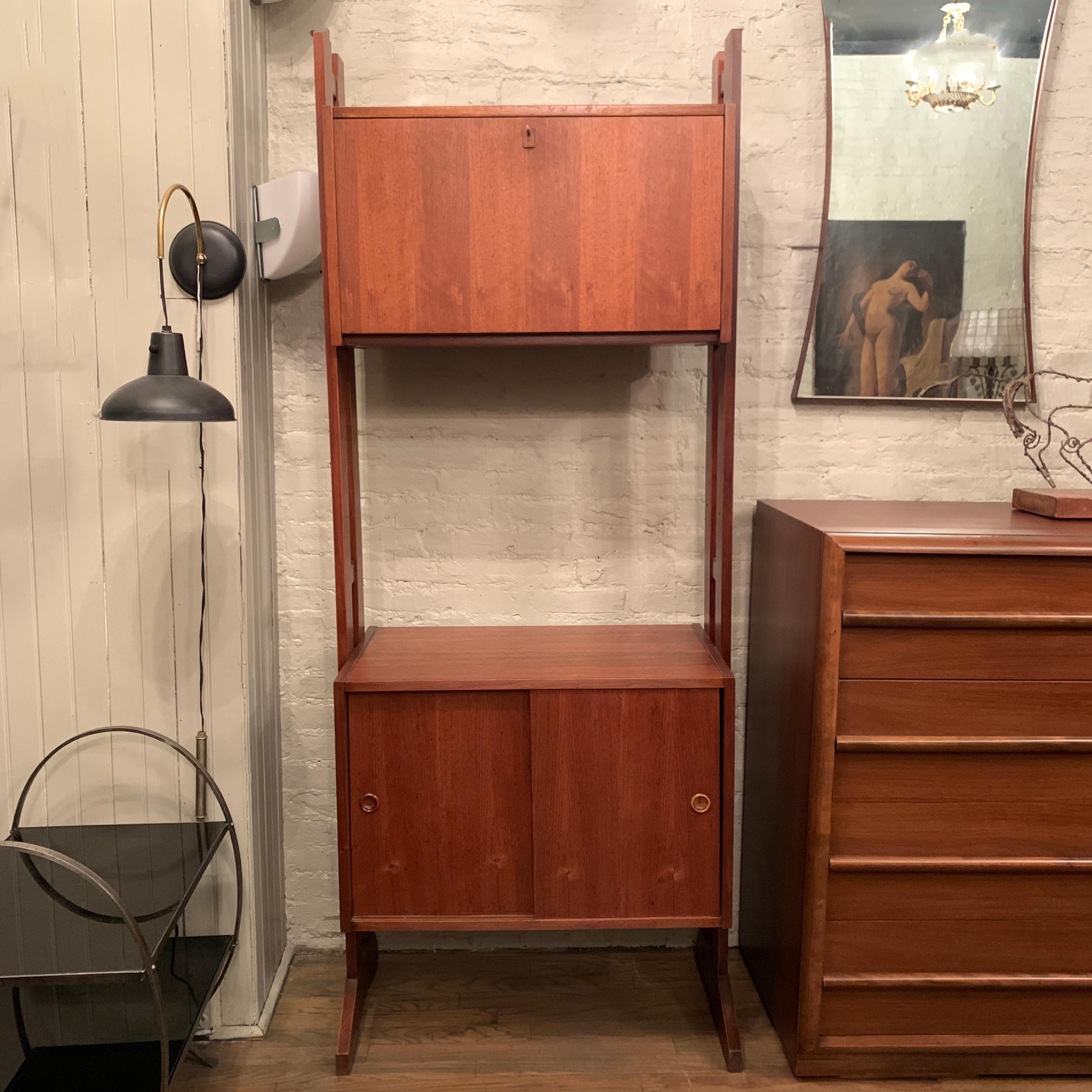 Mid-Century Modern, free standing, walnut, wall unit features divided vinyl record storage on the bottom and a locked top cabinet. The bottom cabinet's height is 18 inches and the top cabinet is 13 inches deep and 15.5 inches height so records can