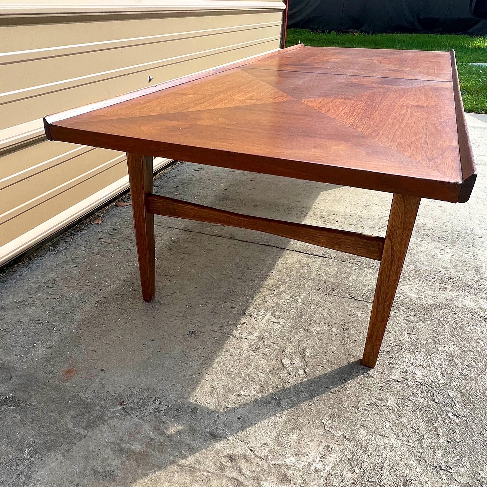 Mid century modern coffee table by American of Martinsville with diamond patterned walnut veneer top. This is a long and low table that will pair nicely with a low profile sofa. It's solid and sturdy and in very good vintage condition.