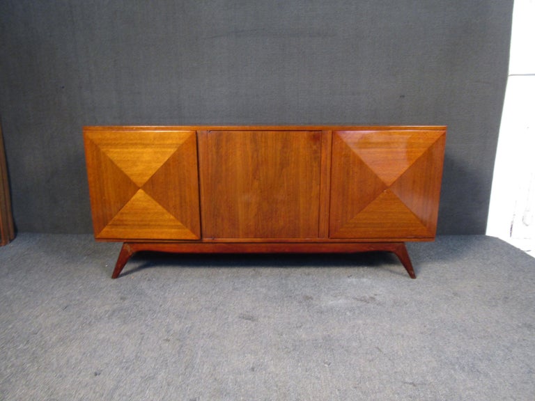 This vintage walnut server features contrasting diagonal panels on its doors, which open to reveal multiple shelves and generous storage. Please confirm item location with seller (NY/NJ).

.