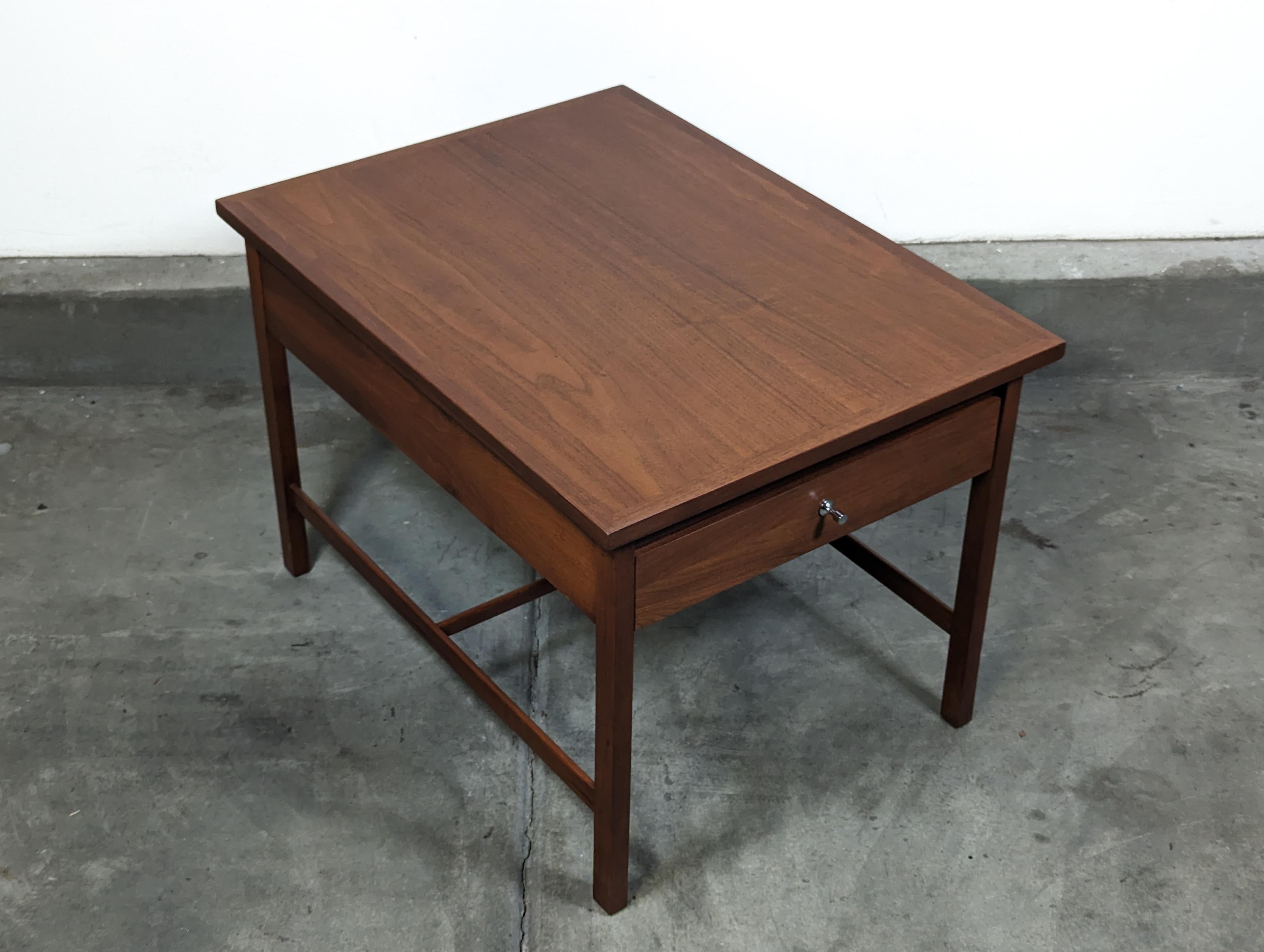 Immerse yourself in the timeless elegance of mid-century modern design with this exquisite side table, a true gem designed by the iconic Paul McCobb for Lane Furniture's celebrated 'Delineator' line. Dating back to the 1960s, this table is a