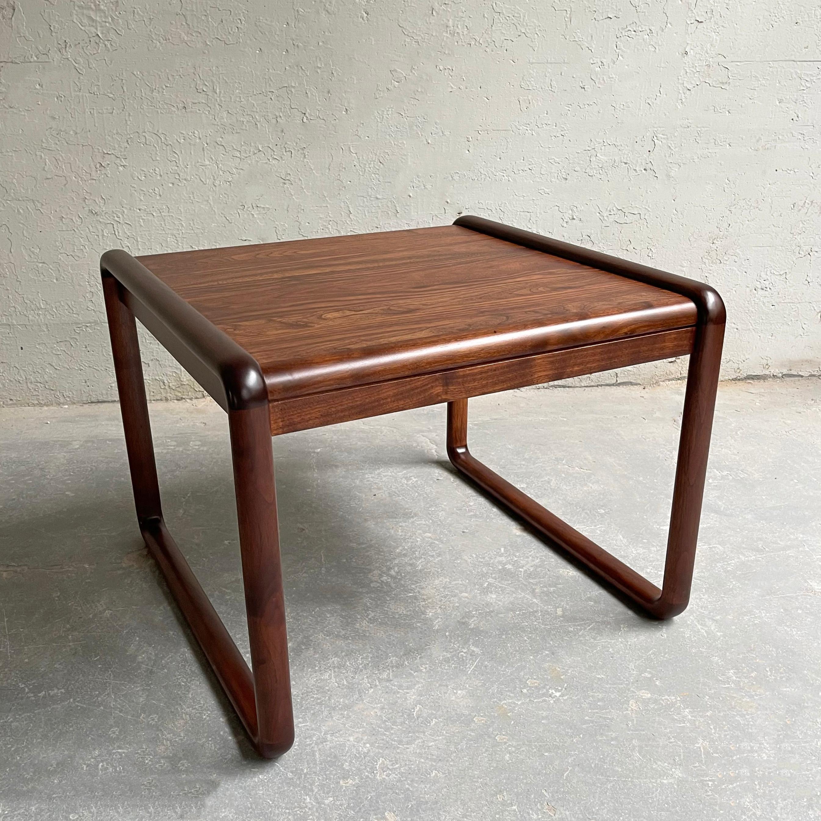 Sleek, Mid-Century Modern, walnut side table by Gunlocke features sculpted sleigh legs.