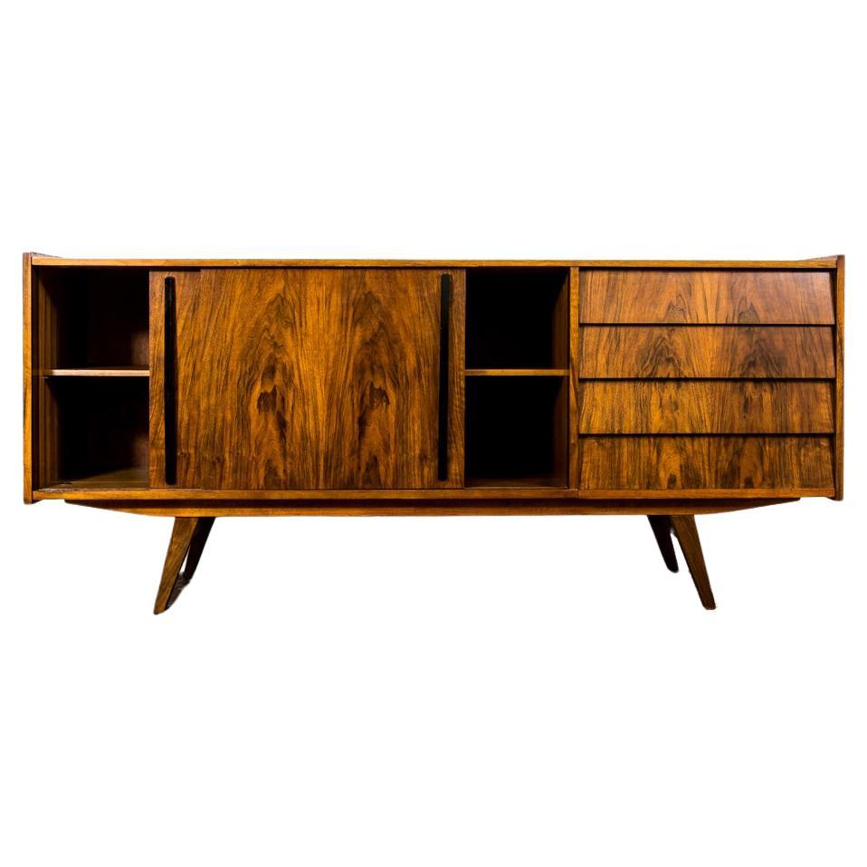 Sideboard by Slupskie Furniture Factory, 1960's, Poland.
Walnut sideboard has been restored and refinished.
Case raised on solid wooden construction and legs.
Sideboard has 2 sliding doors, removable shelf and 4 drawers.
