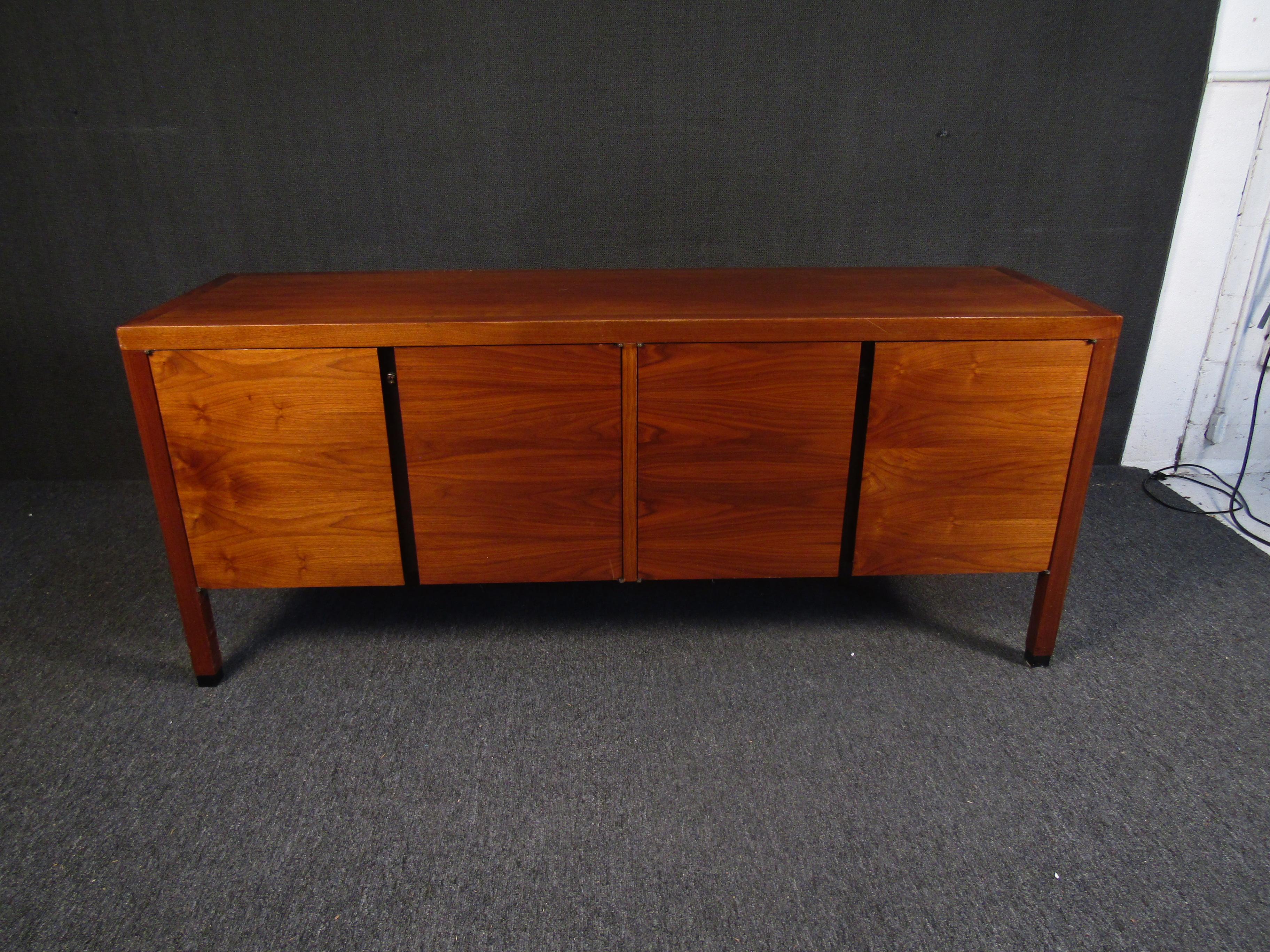 Full of Mid-Century Modern style and quality, this vintage walnut sideboard offers plenty of storage and room for organization. 
Please confirm item location with seller (NY/NJ).