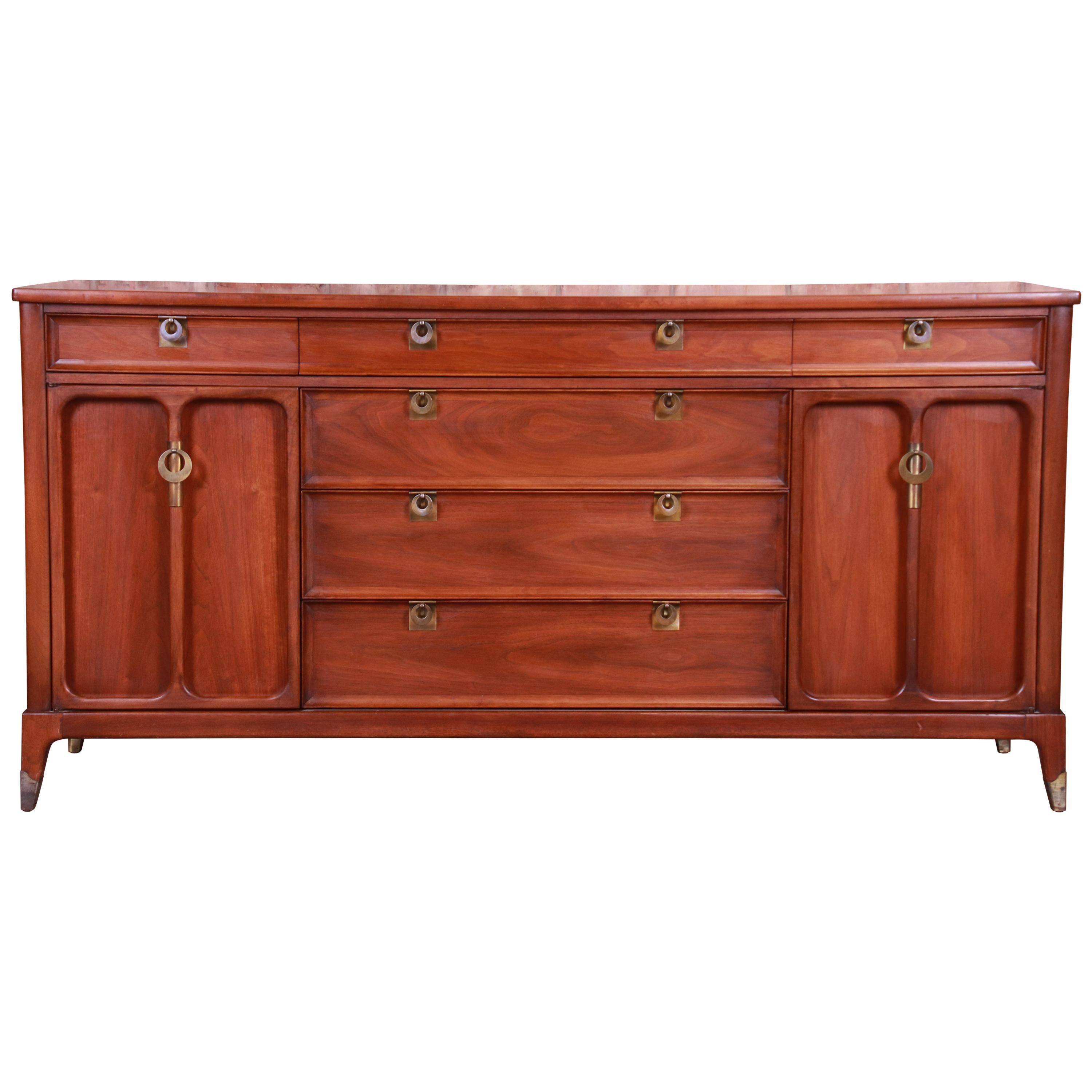 An exceptional Mid-Century Modern sideboard or bar cabinet

By White Furniture Co.

USA, circa 1960s

Bookmatched walnut, with original brass hardware.

Measures: 66.75