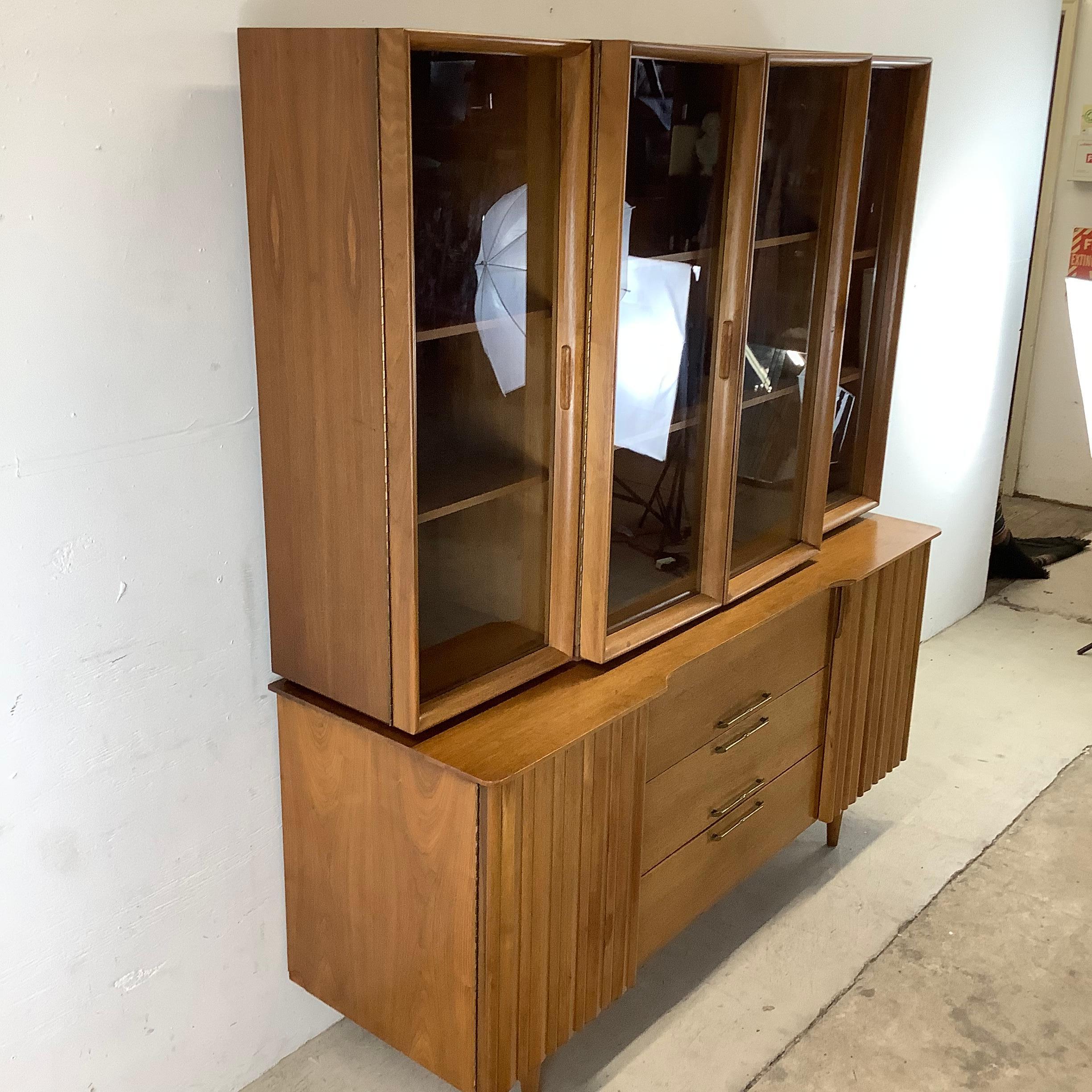 Beautiful Mid-Century Modern sideboard with breakfront display top makes an impressive storage solution for dining room, living room, or any setting. Natural walnut finish, quality vintage construction, Danish Modern design, and spacious interior