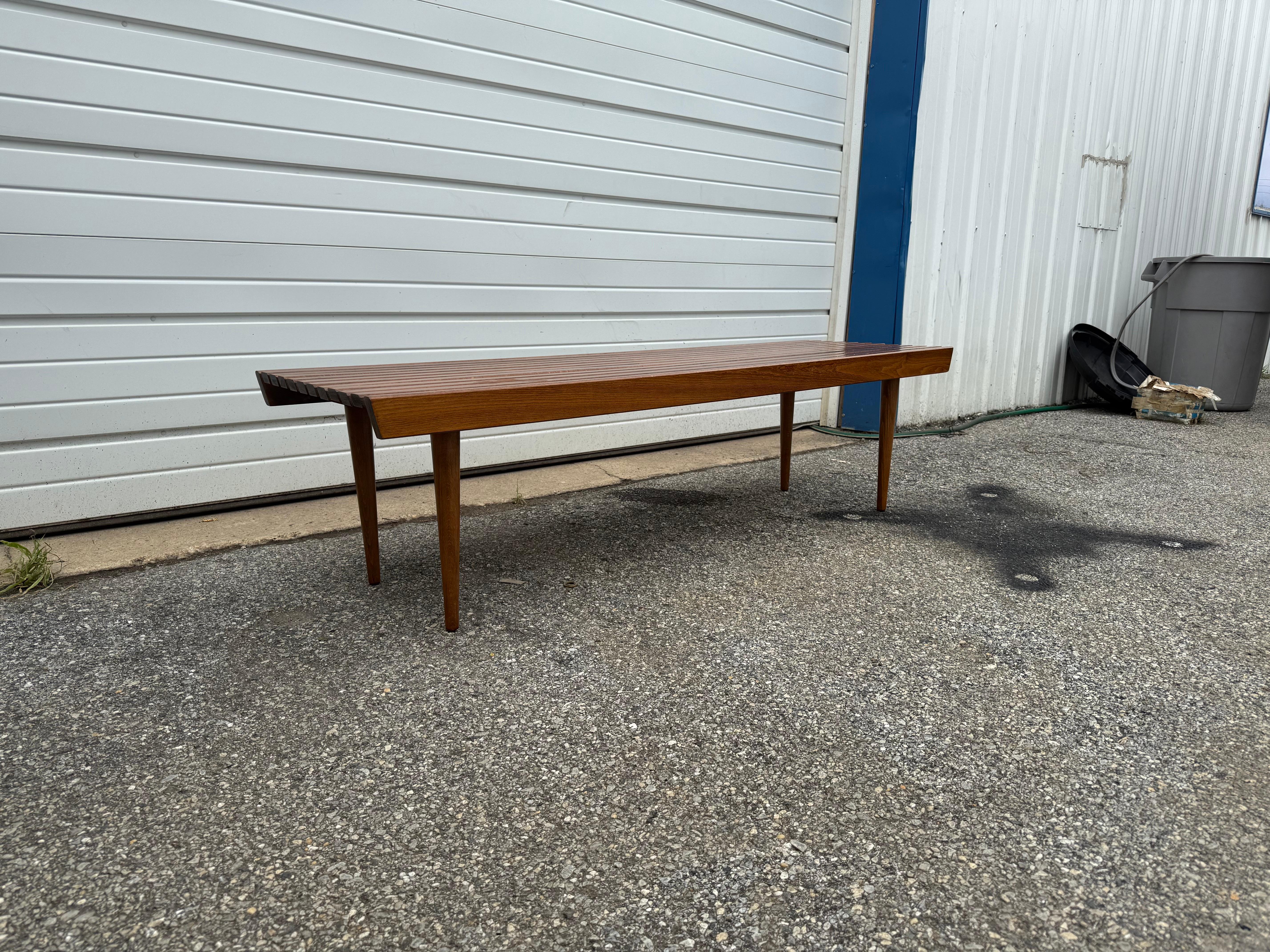 Mid-Century Danish Modern Walnut Slat Bench/Coffee Table B

Offered is a vintage mid-century modern walnut side table. This table is an outstanding representation of the Modern era. The sleek deesign and lines will compliment any design project or
