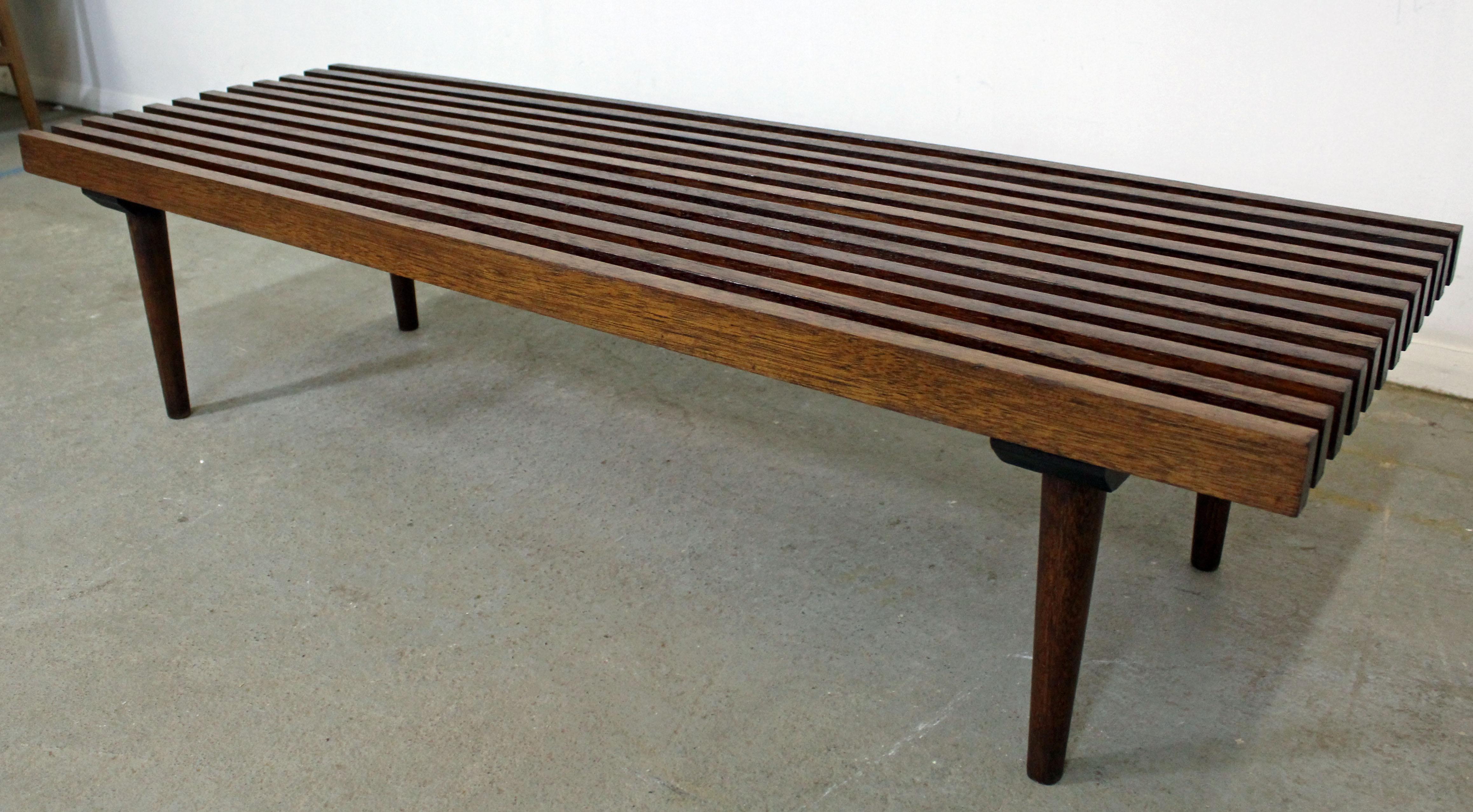 Offered is a Mid-Century Modern walnut slat bench coffee table with brass dowels. It has a nice look and simple lines. It is in good condition, shows some age wear (refinished, small chip on top, age/surface wear- see pictures) but nothing overly
