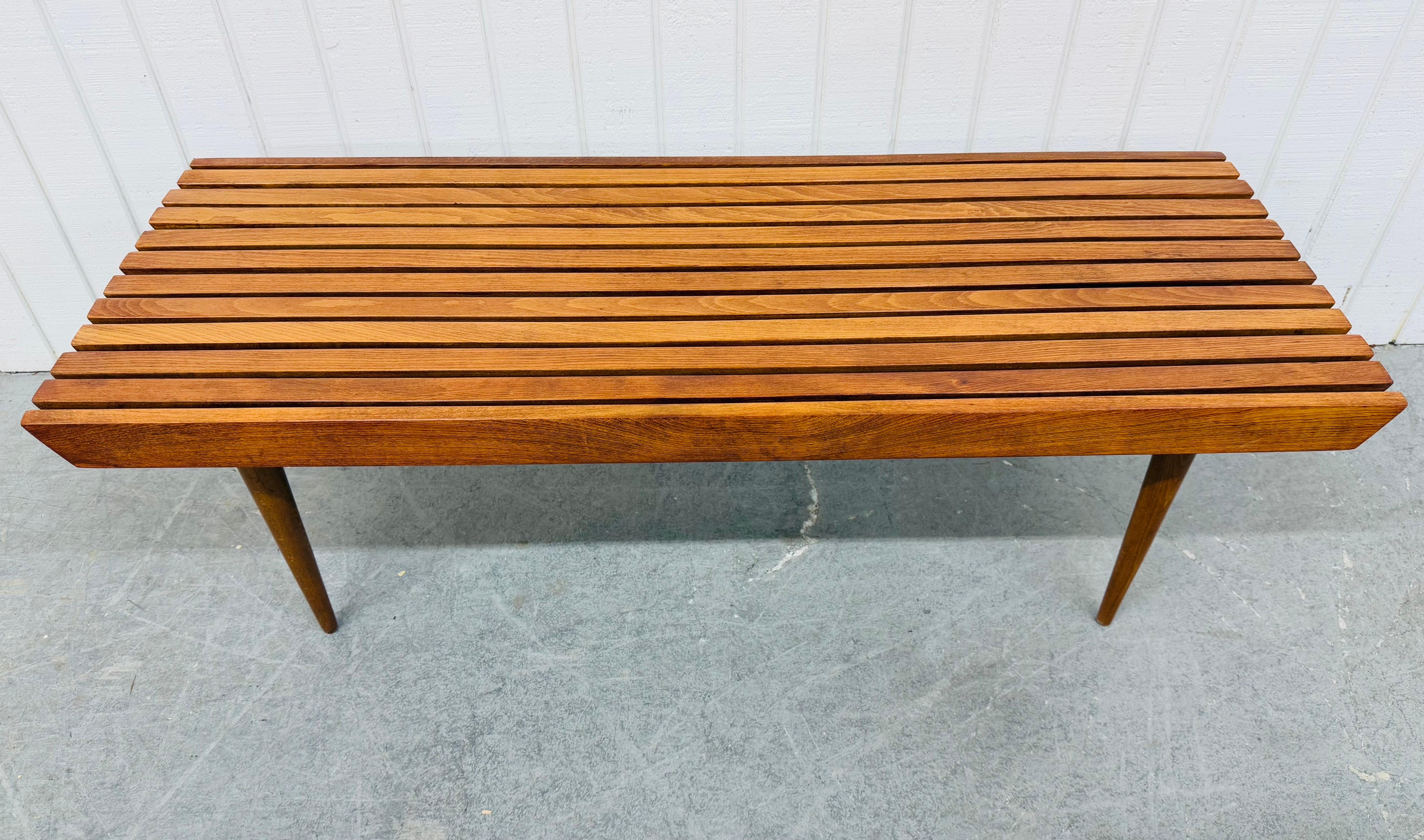 Cette annonce concerne une table basse à lattes en noyer de style moderne du milieu du siècle. Avec un design rectiligne, un plateau rectangulaire en lattes de bois, quatre pieds en bois amovibles et une belle finition en noyer. Il s'agit d'une