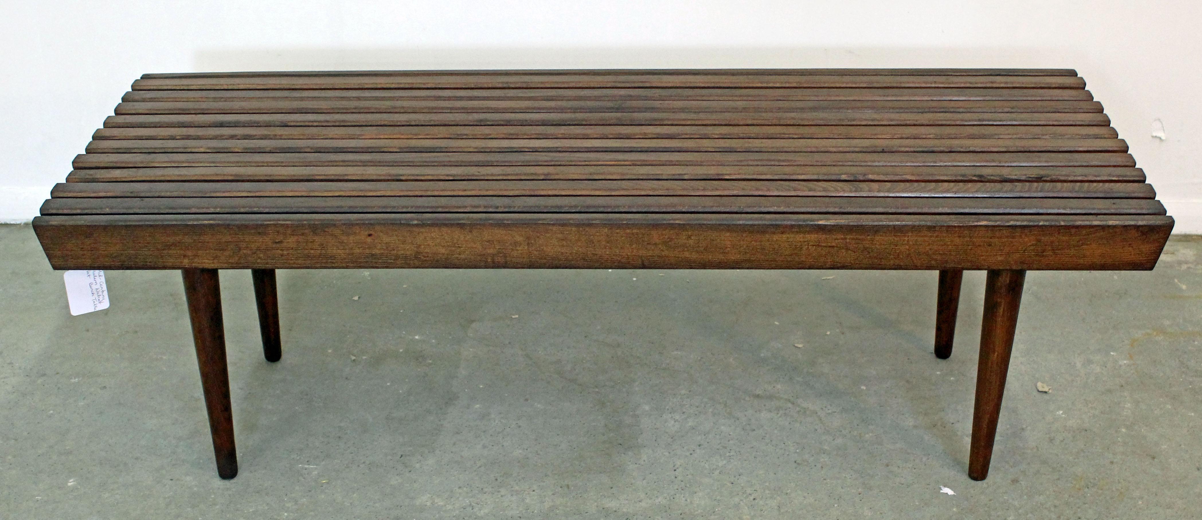 Offered is a Mid-Century Modern walnut slat bench coffee table. It is in excellent condition, showing little age wear (has been refinished, minor chips/wear). It is not signed. Check out our other listings for more vintage, primitive and antique