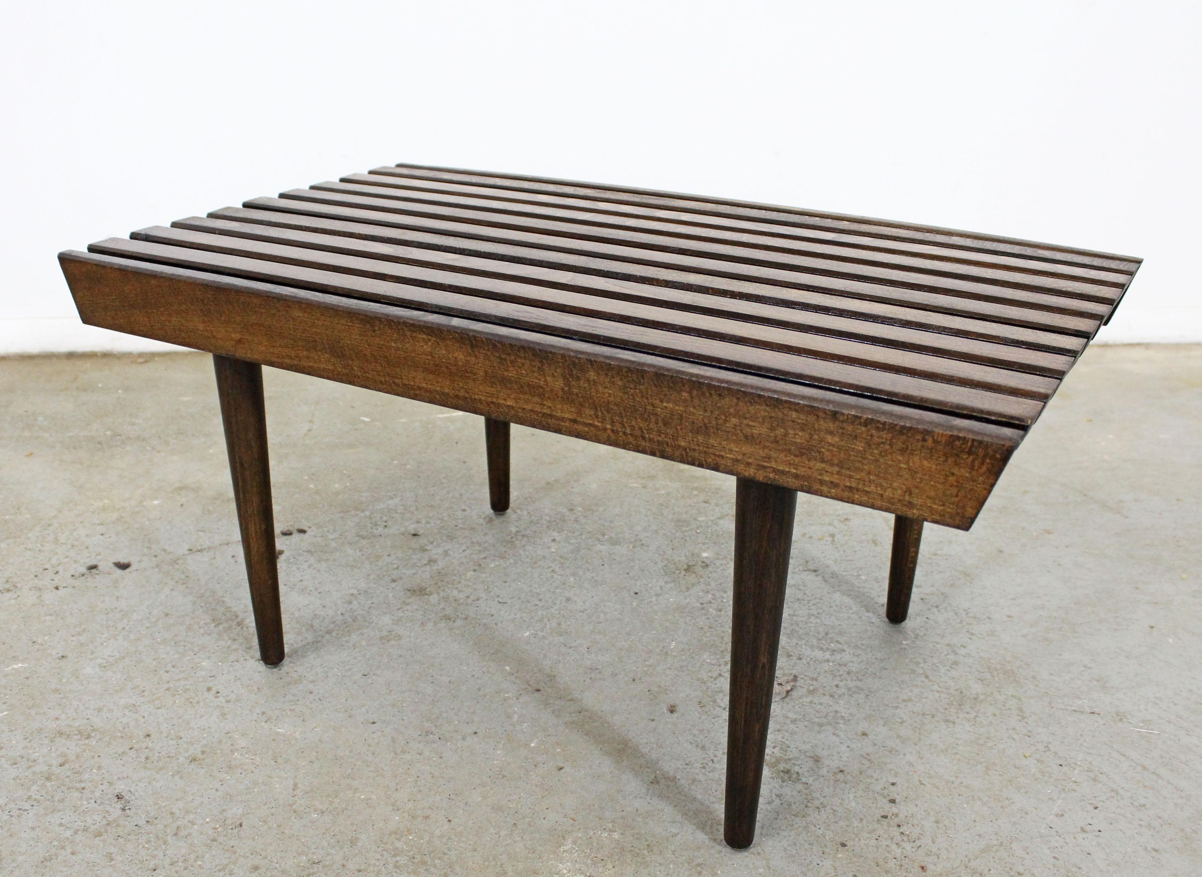 What a find. Offered is a vintage Mid-Century Modern walnut side table. Has been refinished and is in good condition with minor surface wear/chips. It is structurally sound and stabile. It is not signed. Check out our other listings for more
