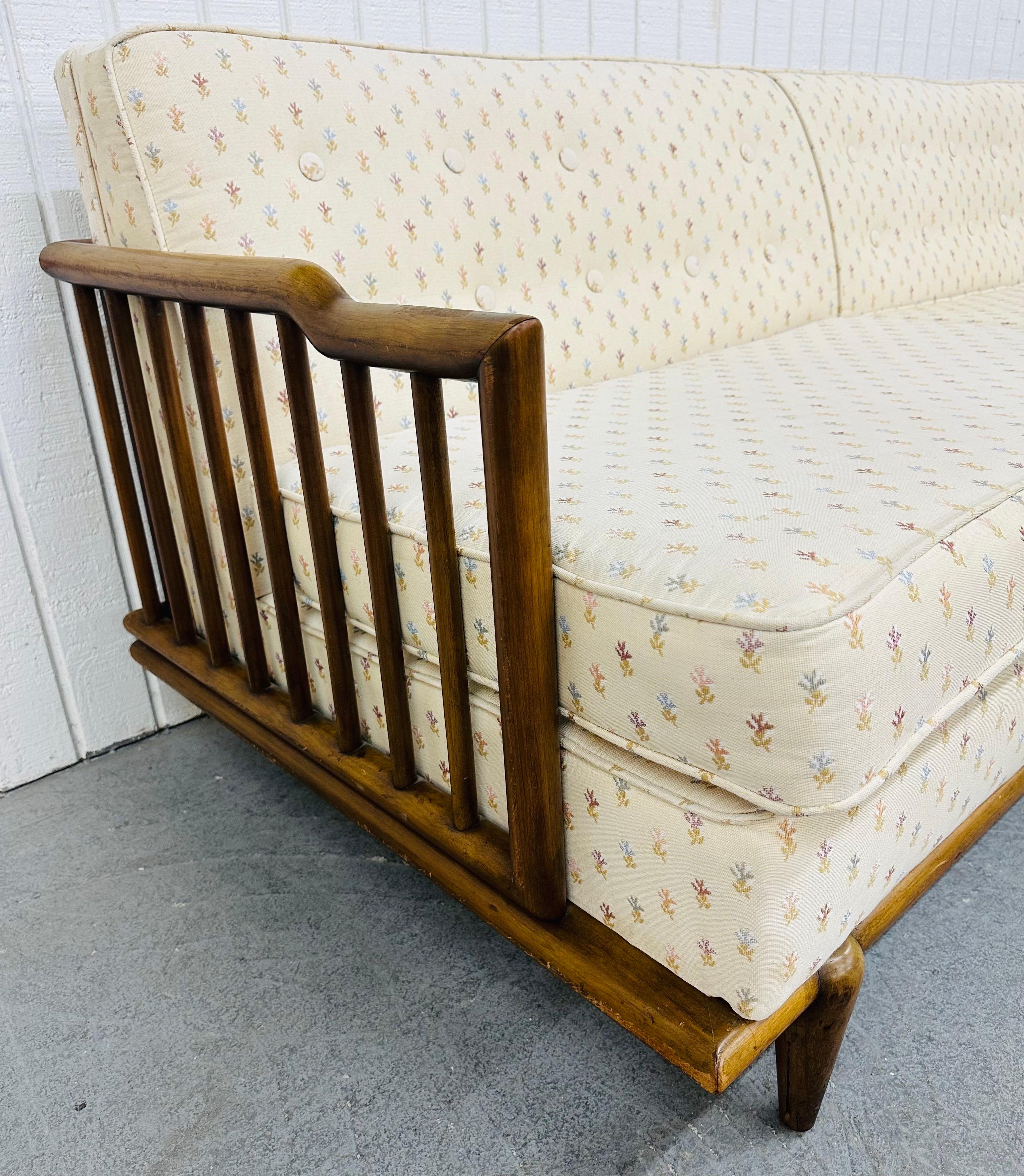 This listing is for a Mid-Century Modern Walnut Sofa. Featuring a straight line design, wooden frame with spindle design, and off-white vintage upholstery. This is an exceptional combination of quality and design! 