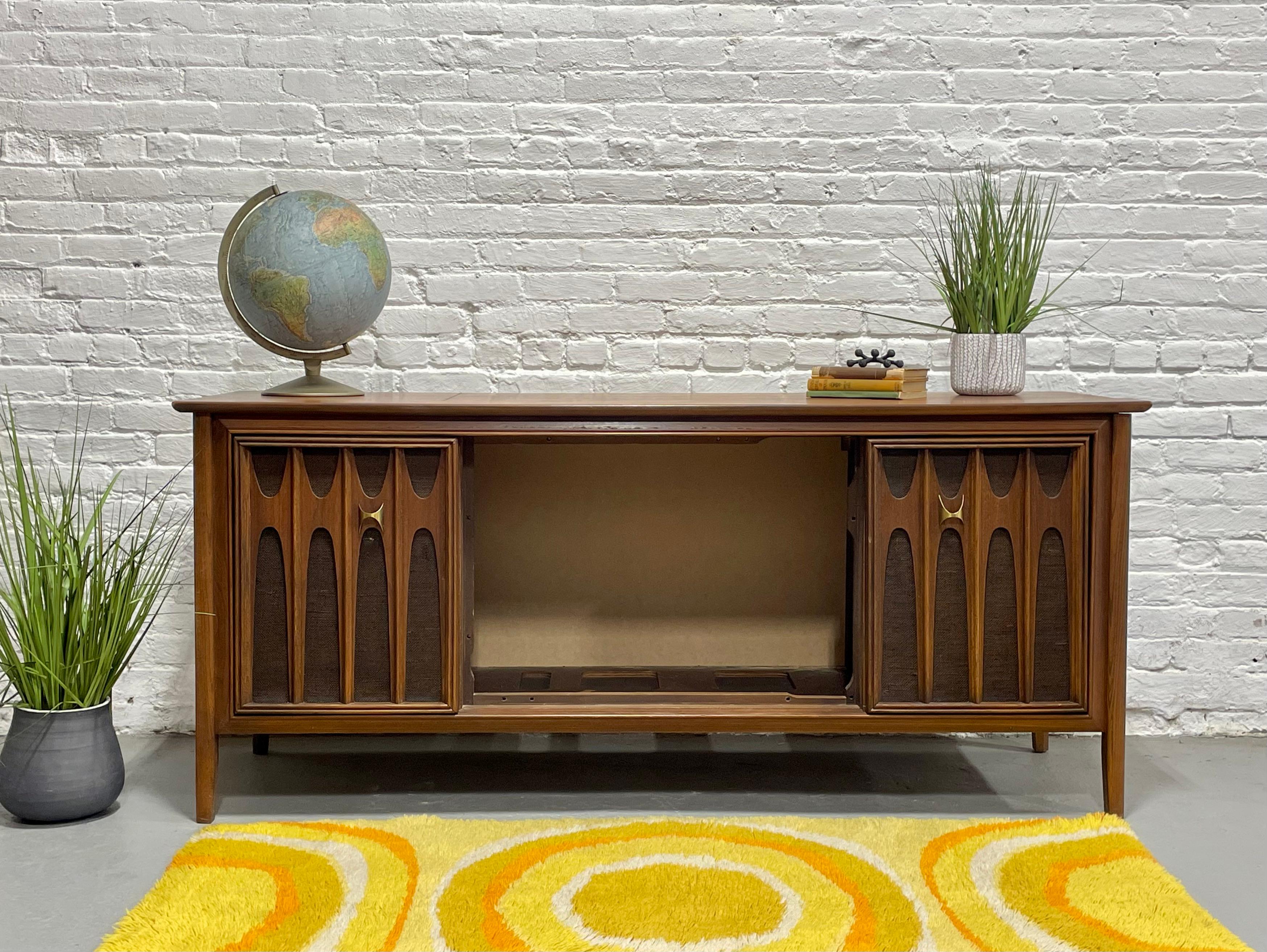 Mid Century Modern Stereo Cabinet / Credenza, c. 1960's in the style of Broyhill Brasilia. This stunning walnut stereo cabinet has had the components removed and offers a blank interior so you can either update it with your own selection of stereo