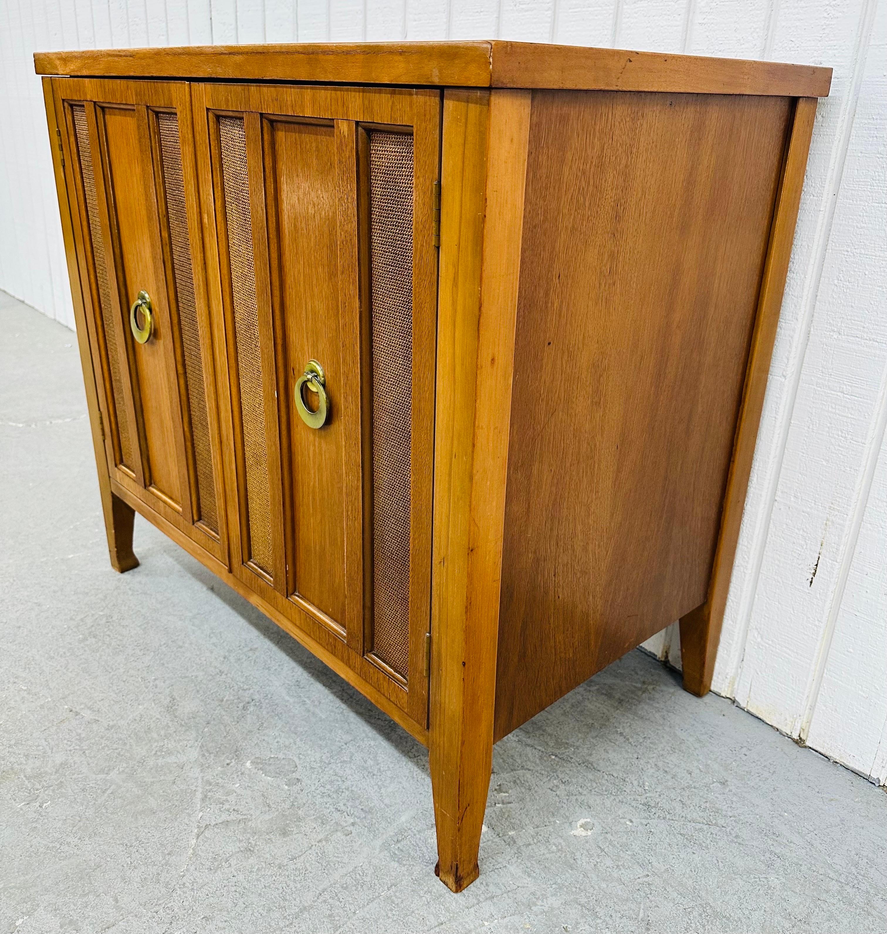 This listing is for a Mid-Century Modern Walnut Storage Cabinet. Featuring a straight line design, rectangular top, two doors with original brass pulls, cane lined doors, modern legs, and a beautiful walnut finish. This is an exceptional combination