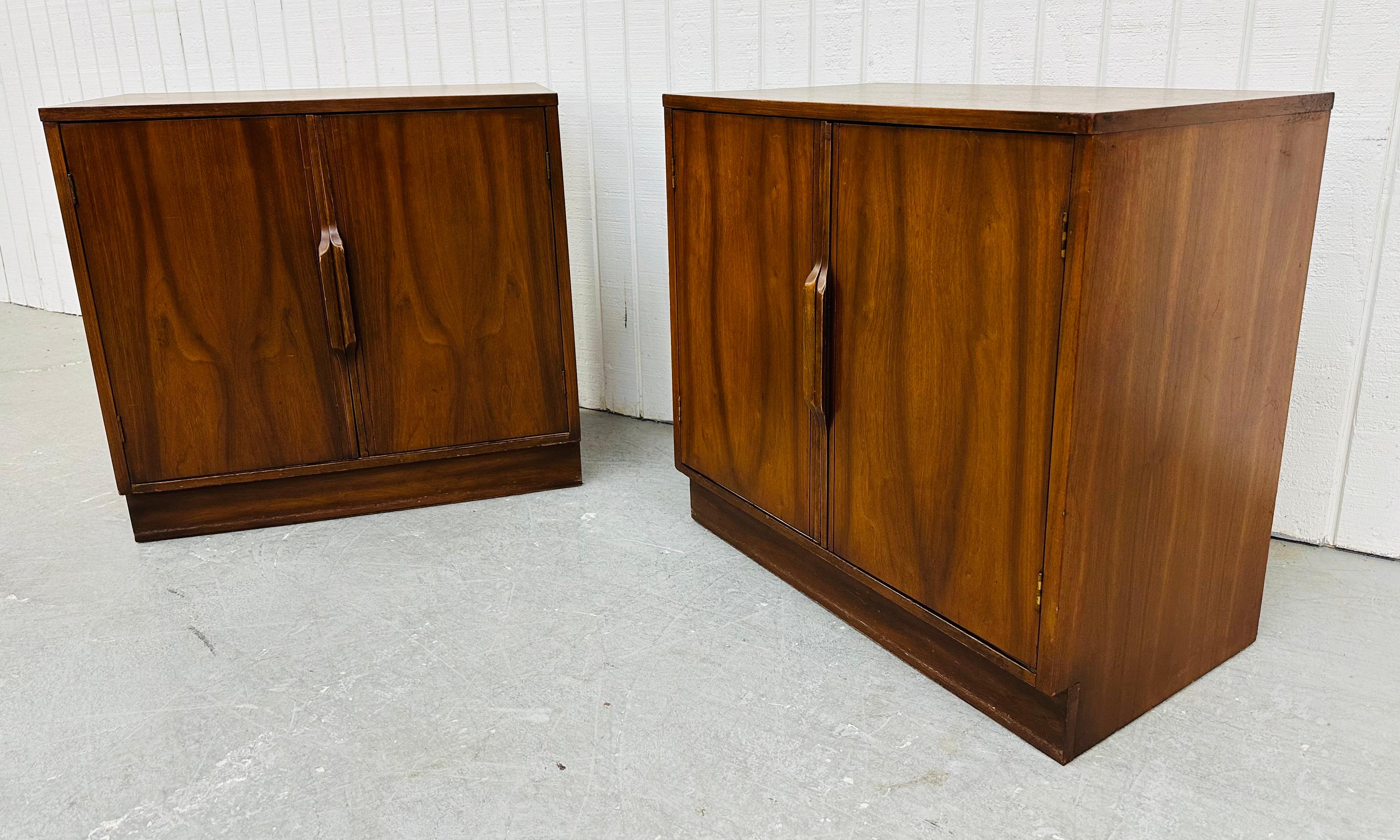 This listing is for a pair of Mid-Century Modern Walnut Storage Cabinets. Featuring a straight line design, two doors with wooden pulls that open up to storage space, plinth base, and a beautiful walnut finish! This is an exceptional combination of