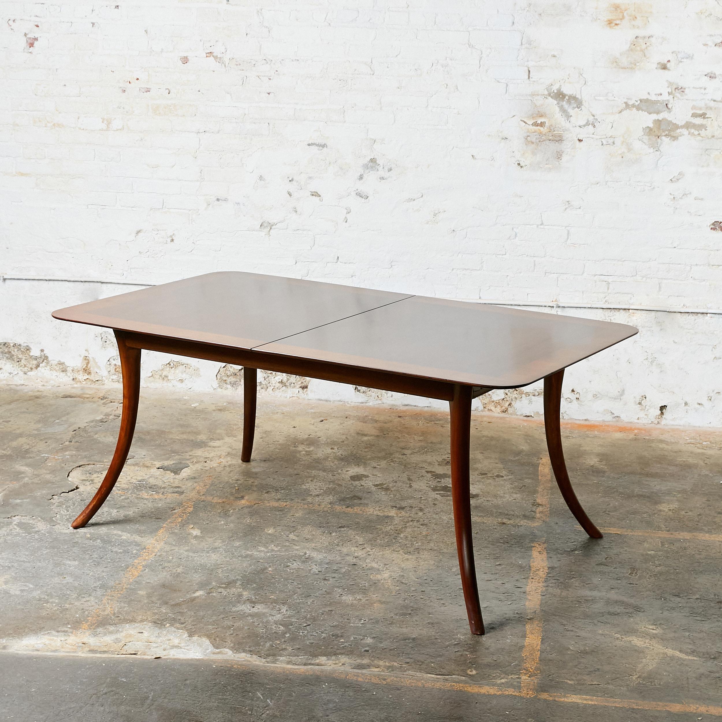 Mid-Century Modern dining table with saber legs. Designed by Robsjohn Gibbings for Widdicomb. This table does not include extension leaves.