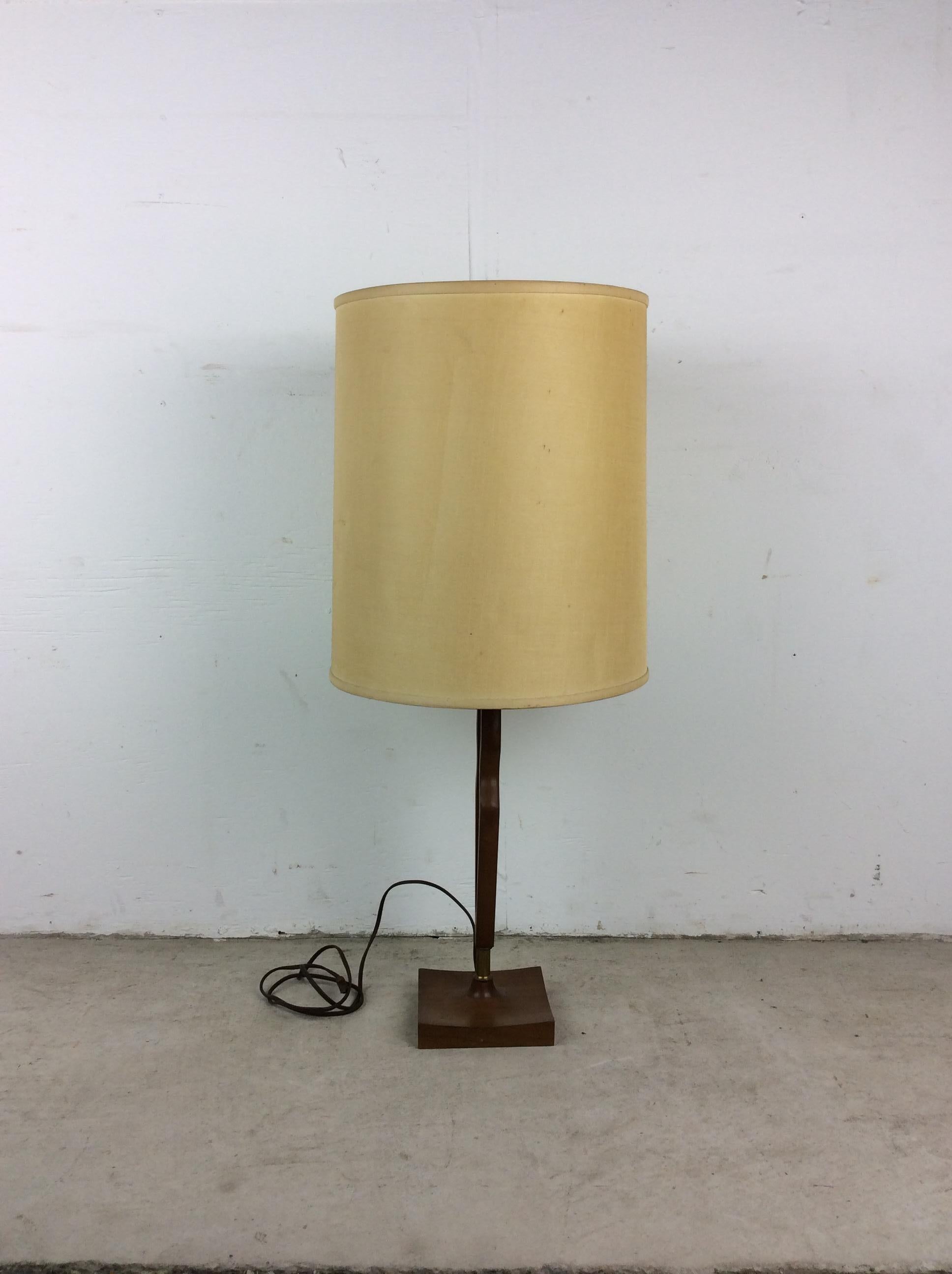 This mid century modern table lamp features unique walnut construction with brass accent and vintage barrel shade.

 Dimensions: 6w 6d 30h
Measurements do not include shade.

Condition: Original wiring works. Vintage shade is in fair condition. The