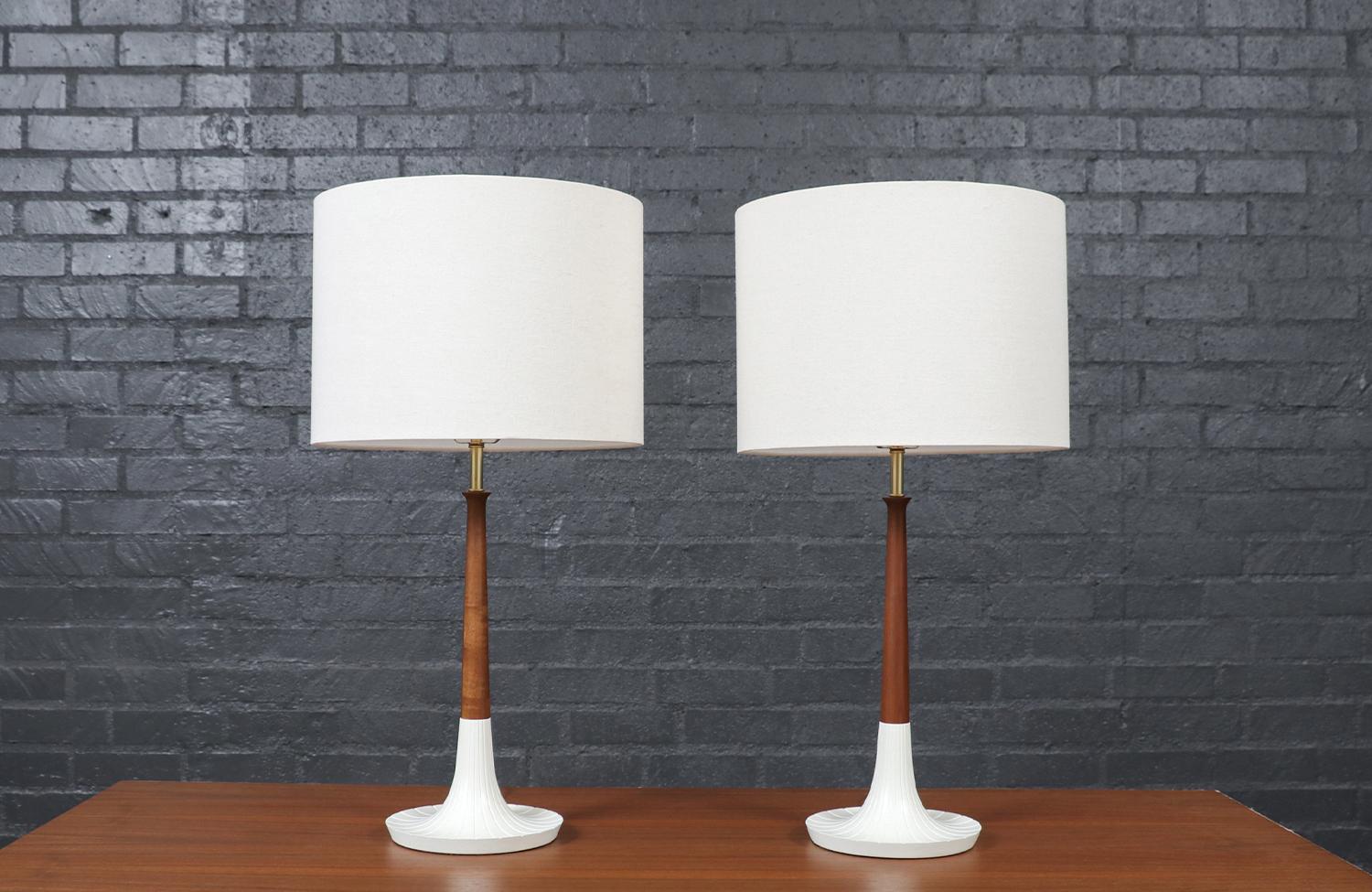 This striking Mid-Century Modern table lamp by Phil-Mar is a perfect blend of bold design and expert craftsmanship. The ceramic body features a vibrant orange glaze with textured lava-like bands, adding depth and dimension to its sculptural form.