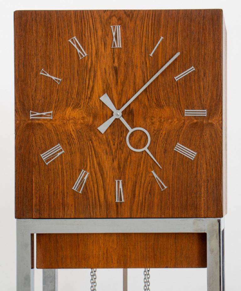 Mid-century modern walnut and chrome tall case clock with interior lights, circa 1960s.  

Dealer: S138XX