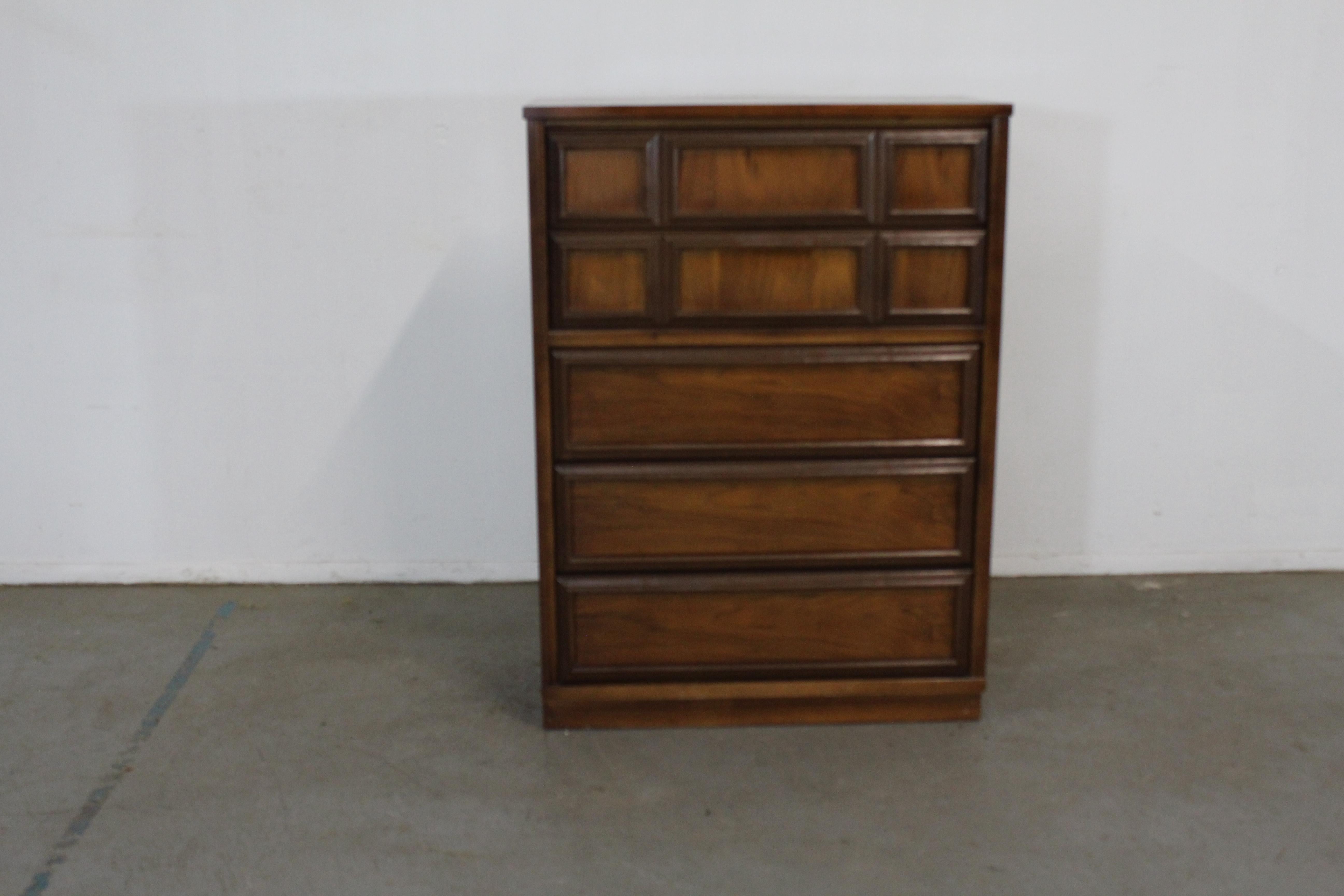 Mid-Century Modern walnut gentleman's tall chest.

Offered is an excellent example of American Mid-Century Modern design; a walnut dresser from the 1960's. Features dovetailed drawers with Walnut trim and sculpted pulls. It is in good condition