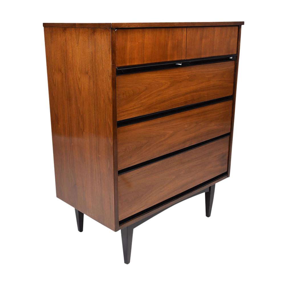 A vintage Mid-Century Modern-style chest of drawers crafted of walnut wood that has been stained in rich walnut & black color combination and a newly lacquered finish. The chest features a flat top, four large drawers below with ample storage space,
