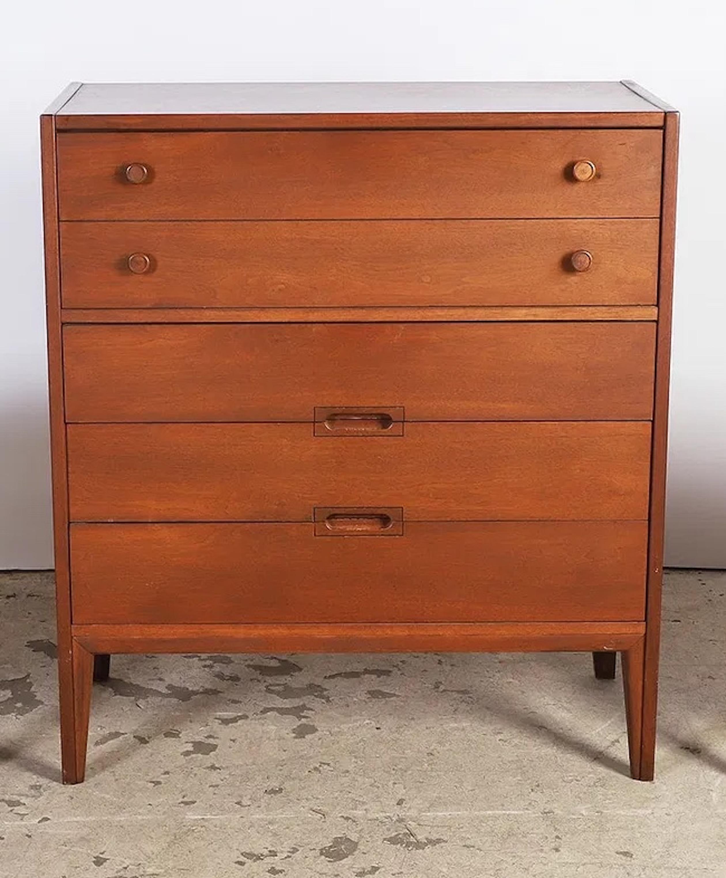 Mid-century modern tallboy chest featuring four spacious drawers and a warm walnut finish. Simple lines and subtle shaping highlight the grain, giving timeless mid-century look. A versatile piece that works well in both modern and classic interiors.