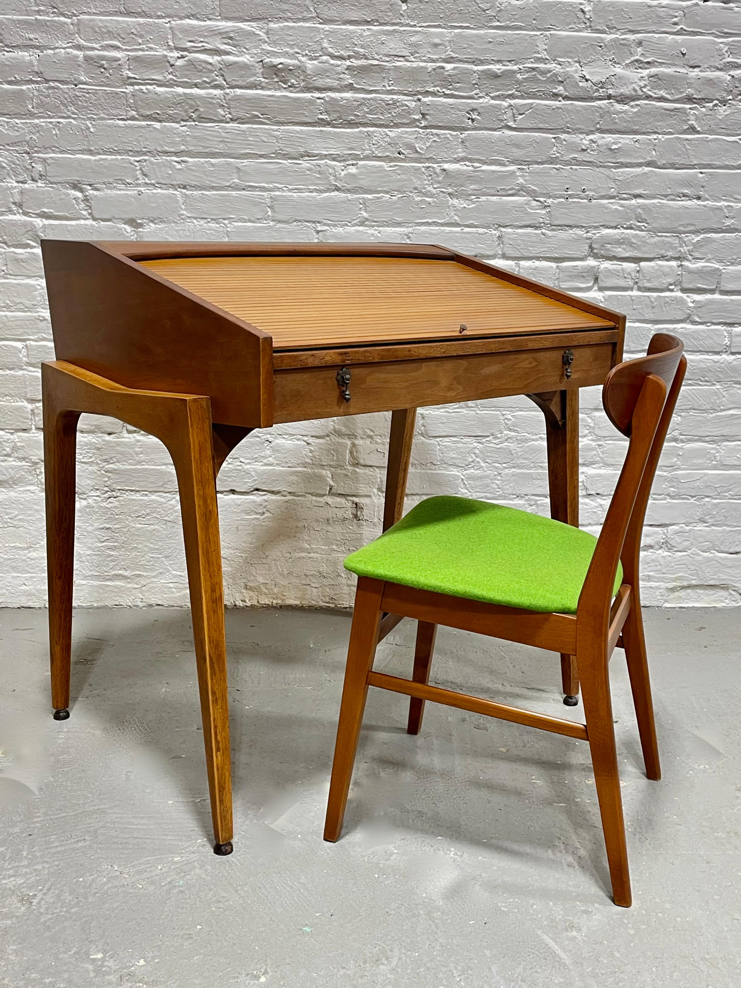 Mid Century Modern Walnut Tambour Top Desk by John Van Koert for Drexel, distributed by John A. Colby & Sons, c. 1955. Incredible profile with the legs giving the desk a floating appearance. The tambour top allows you to hide away your work space
