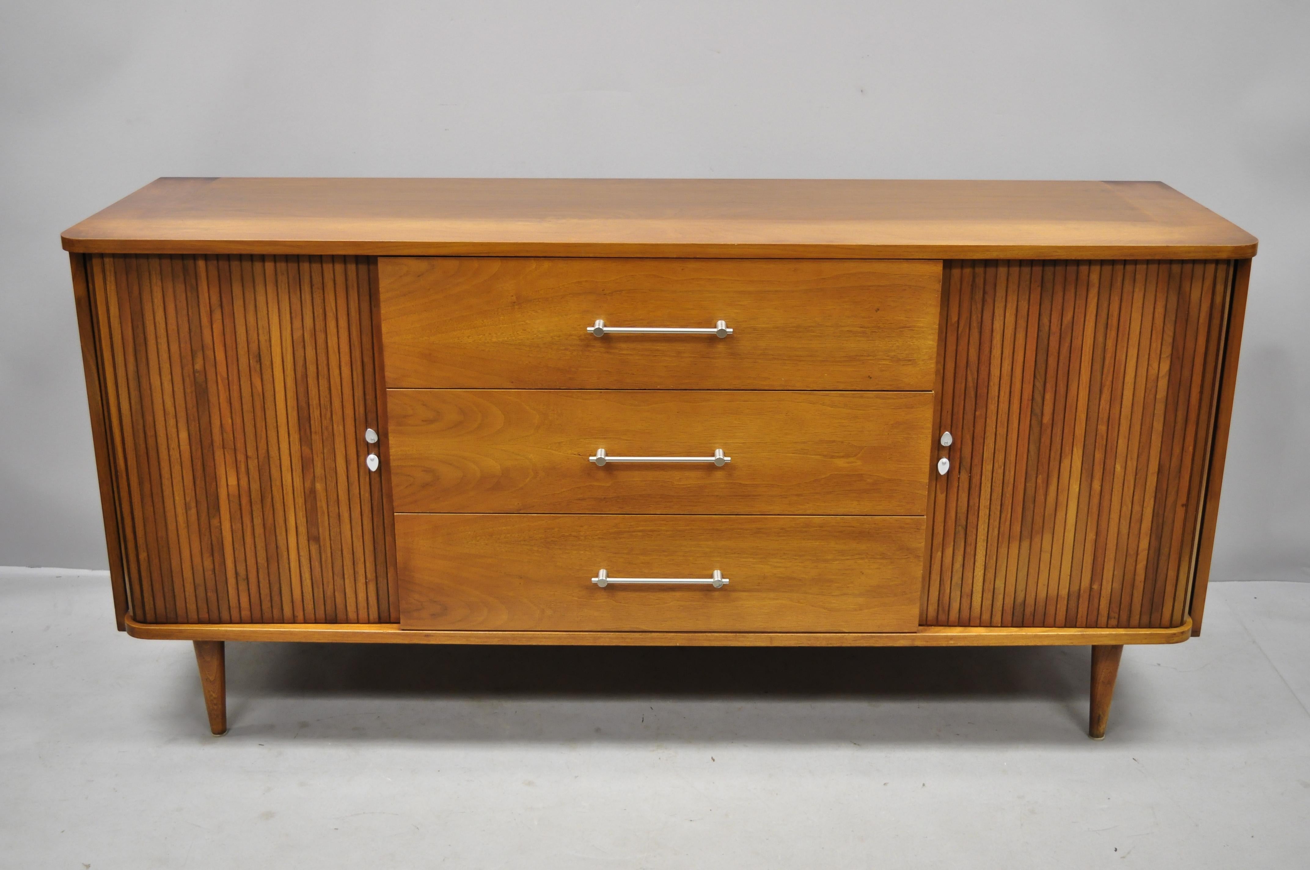 Vintage Mid-Century Modern walnut tambour sliding door Credenza cabinet John Cameron. Item features two tambour sliding doors, beautiful wood grain, 4 dovetailed drawers, tapered legs, clean modernist lines, quality American craftsmanship, circa