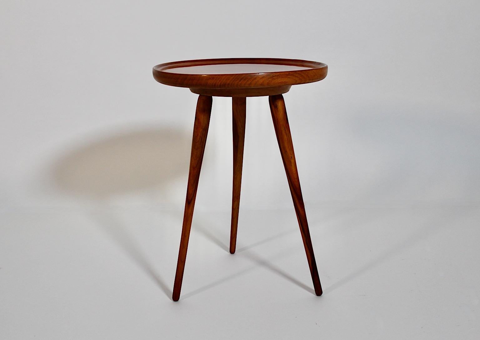 Mid-Century Modern vintage tiny side table or flower stand from walnut and solid beech in smoothly brown color 1950s Austria.
A charming side table or flower stand with three (3) feet and a circular plate with a bent upwards trim.
This amazing side