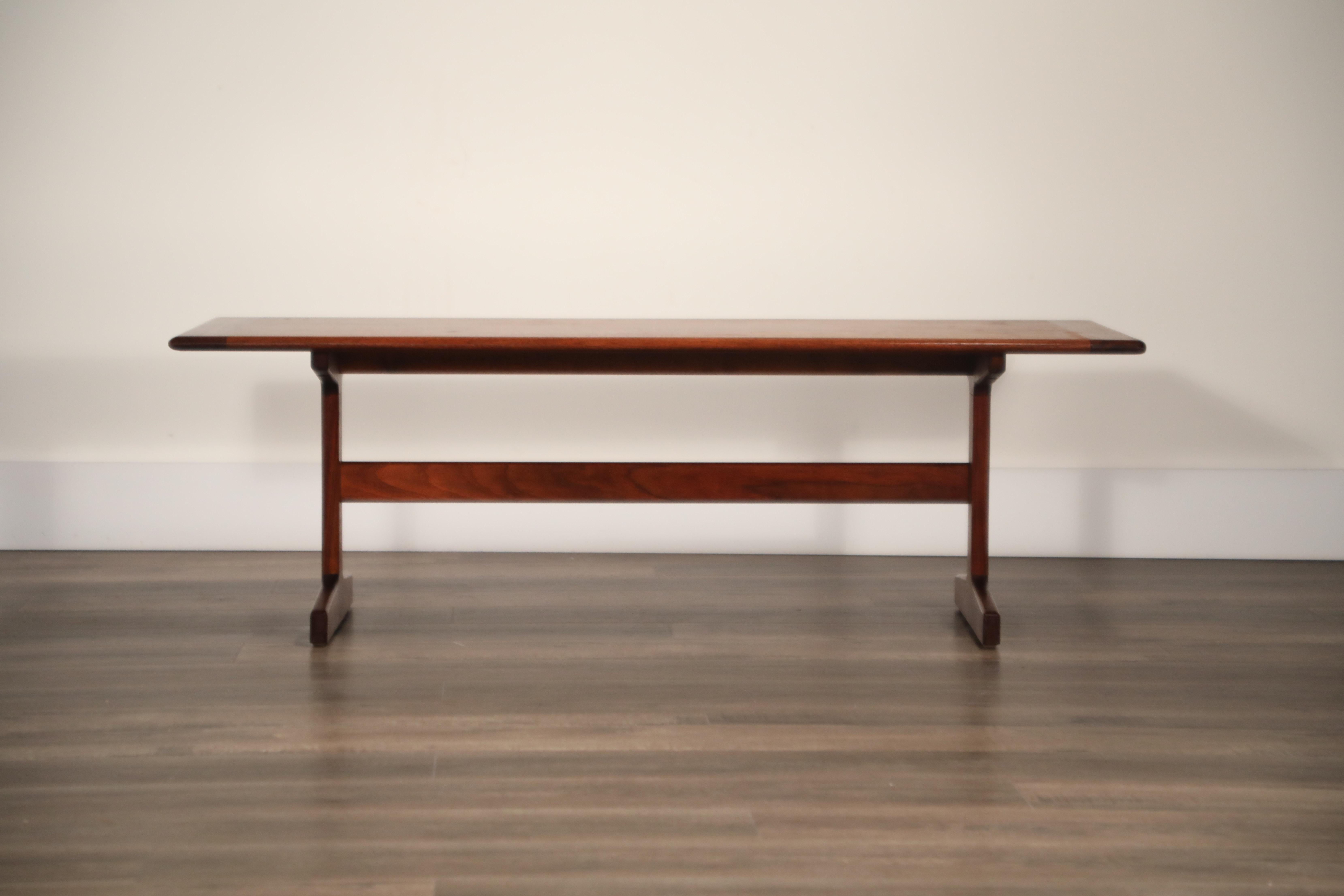 This Mid-Century Modern walnut trestle coffee table has incredible wood grain and would be a perfect fit in your home or office. The trestle base gives it plenty of adaptability to fit any style room and pair with furniture from the 1800s through