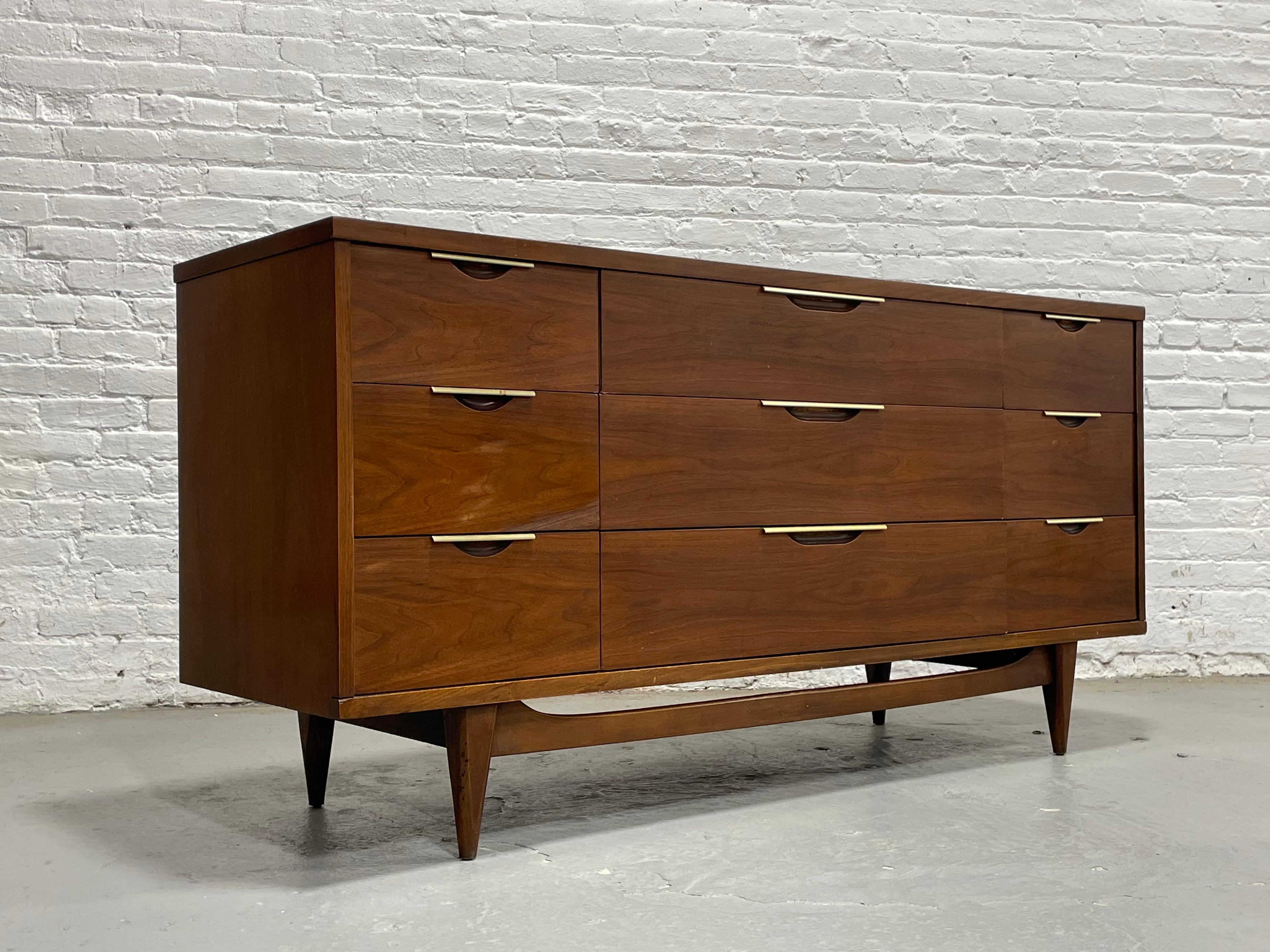 Mid Century Modern Walnut Triple Dresser by Kent Coffey's Tableau Line, circa 1960's. This lovely piece features NINE deep and spacious drawers for plenty of storage space. This piece will be a work horse in your bedroom, storing bulkier items such