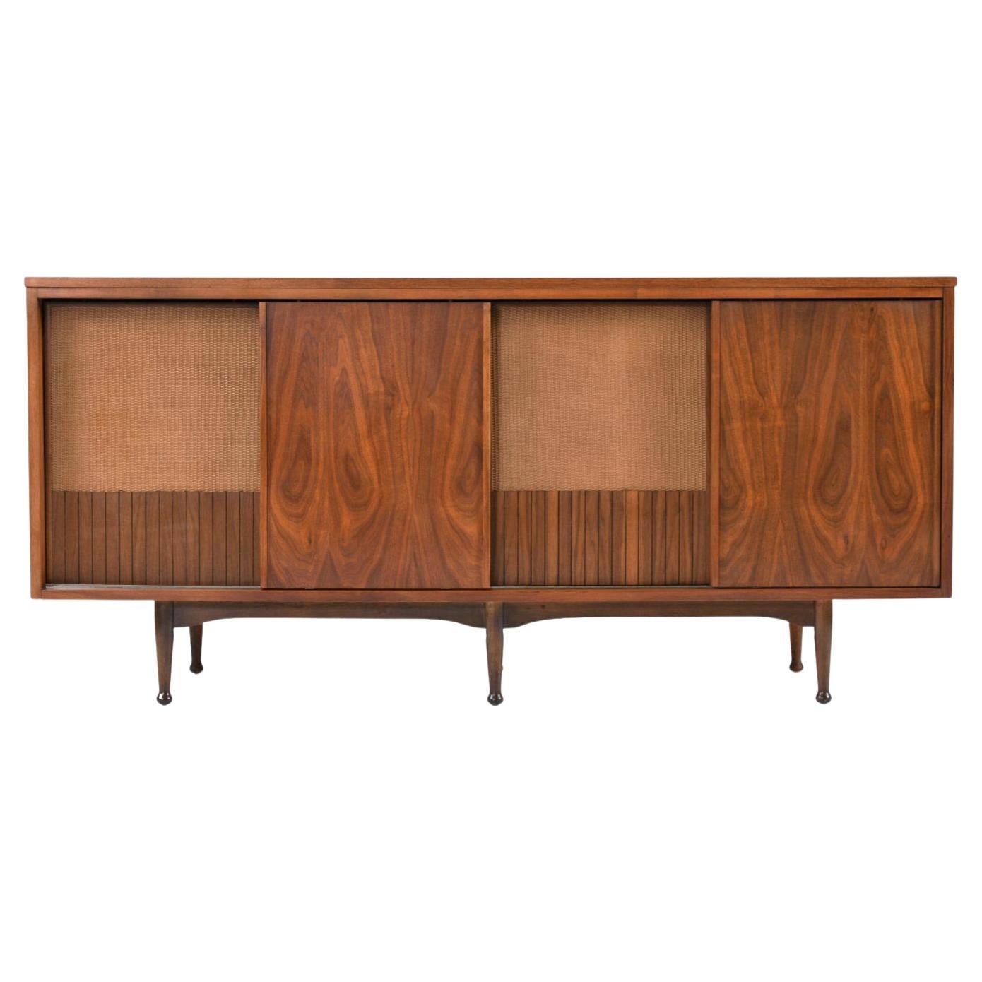 Mainline by Hooker Credenza. This rare find is a true Mid-Century Modern TV stand media center. The sliding doors allow easy access to the three bay entertainment center. The left and right sides both have open cabinet space with a single wood