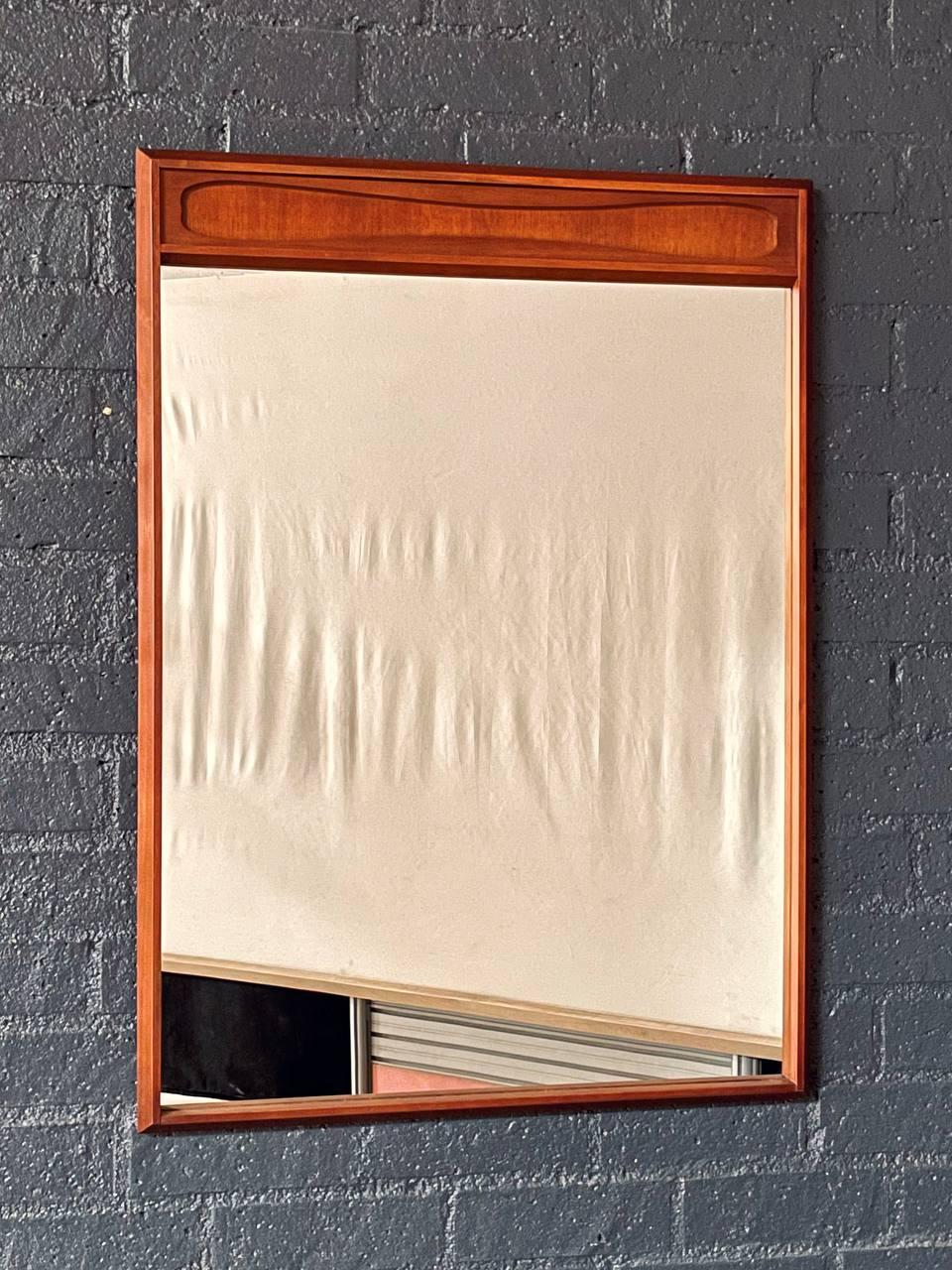 Estado: Estado original de época 

Materiales: Nogal, Espejo de cristal original

Este espejo de pared moderno de mediados de siglo, fabricado en la década de 1960, tiene un cálido marco de nogal de líneas limpias y sutiles detalles tallados en el