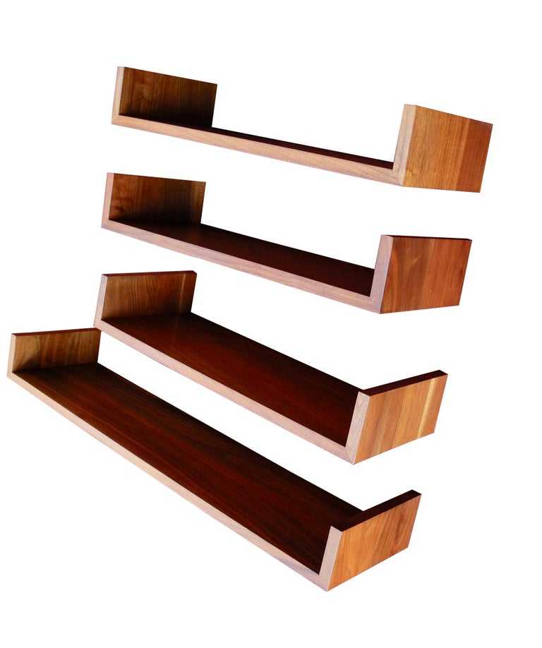 Hang these handsome wall mount walnut shelves at any height and configuration. Designed by Mel Smilow, three of these modern shelves are 24