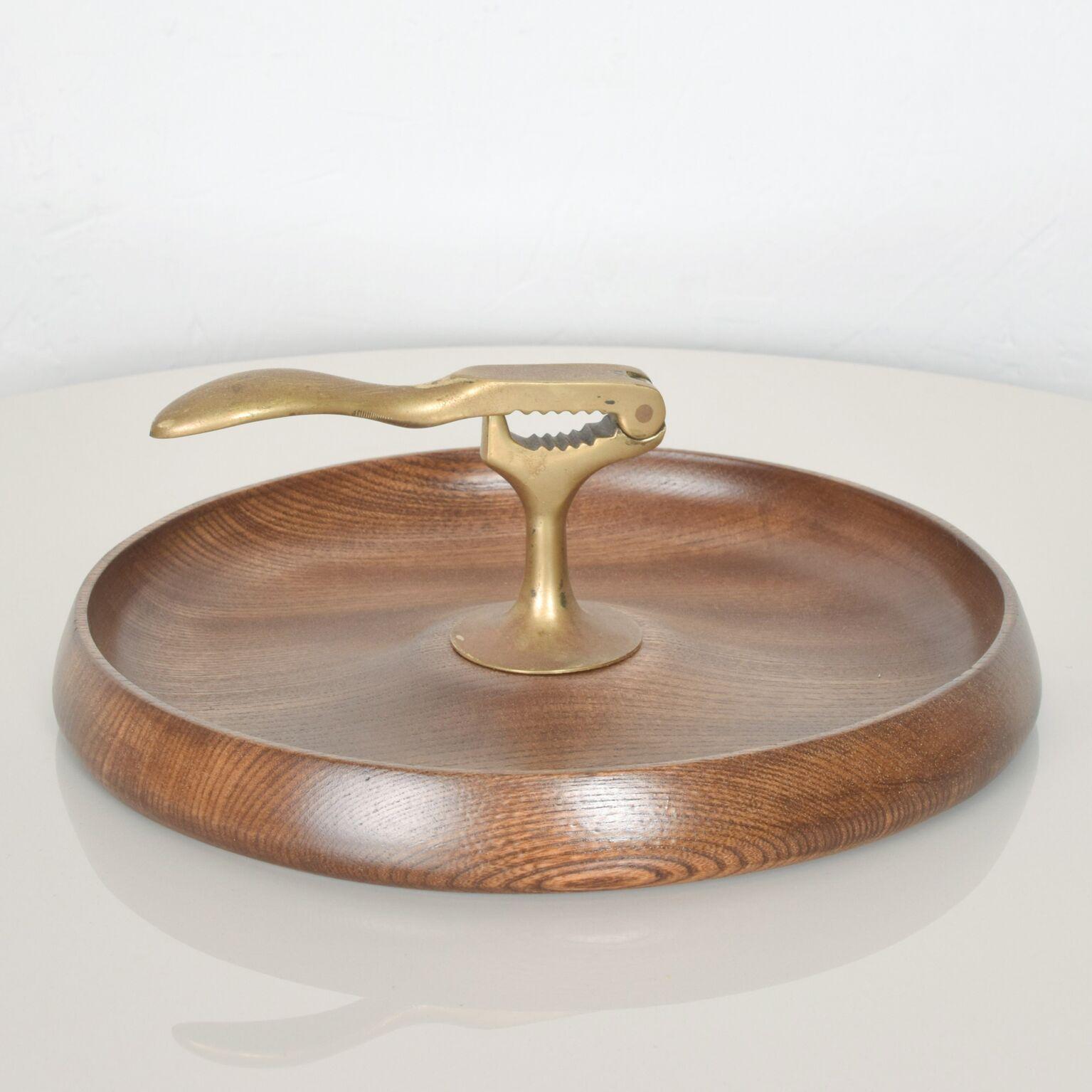 For your fun: Midcentury mad nutcracker with solid bronze hardware in turned walnut wood. No label present. Vintage item, circa 1960s. Lovely serving bowl, tray, dish for nuts. Sleek and modern. Dimensions: 10