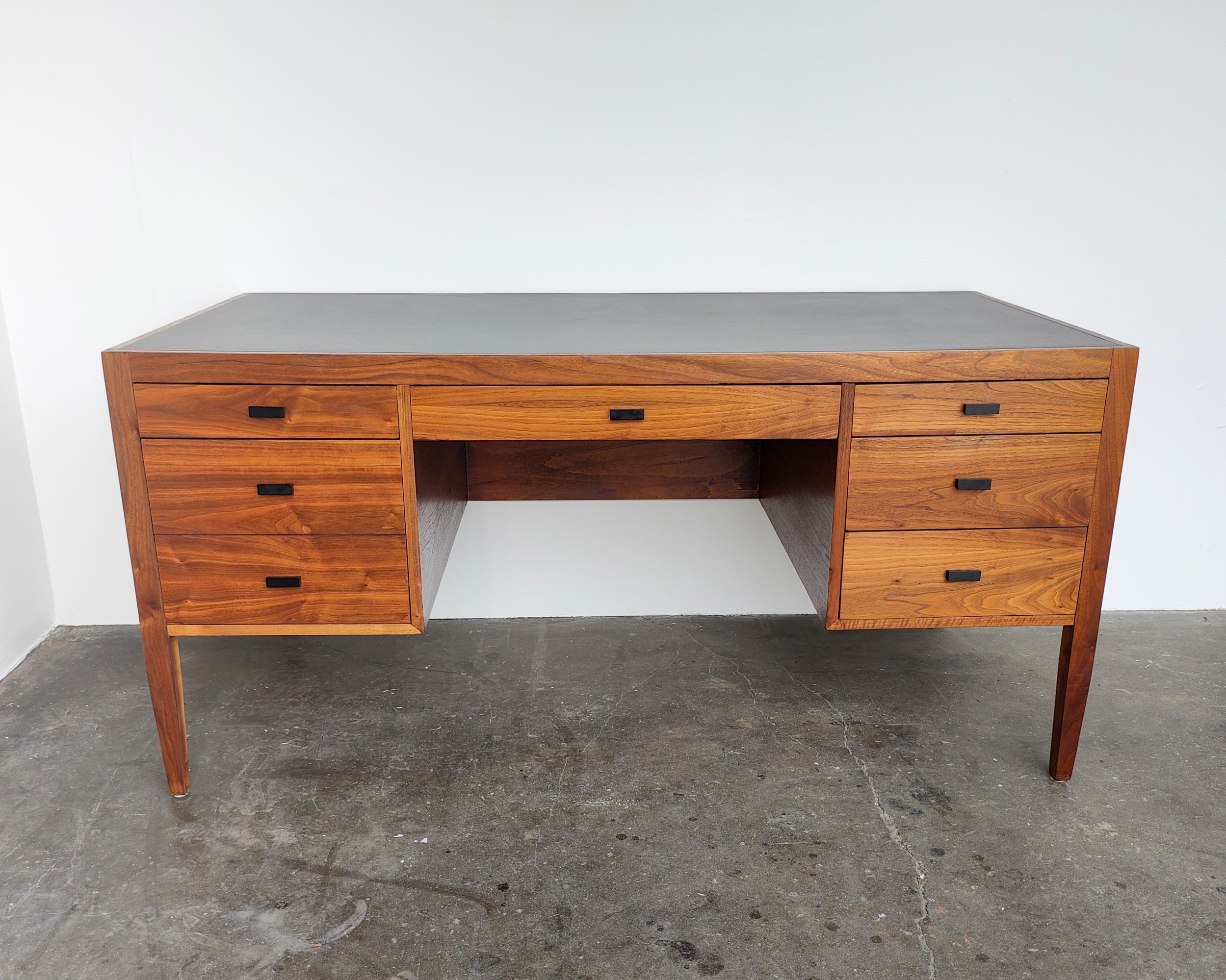 • Mid-20th century
• Refinished walnut wood with original black laminate top
• Six drawers, including one filing drawer
• 60