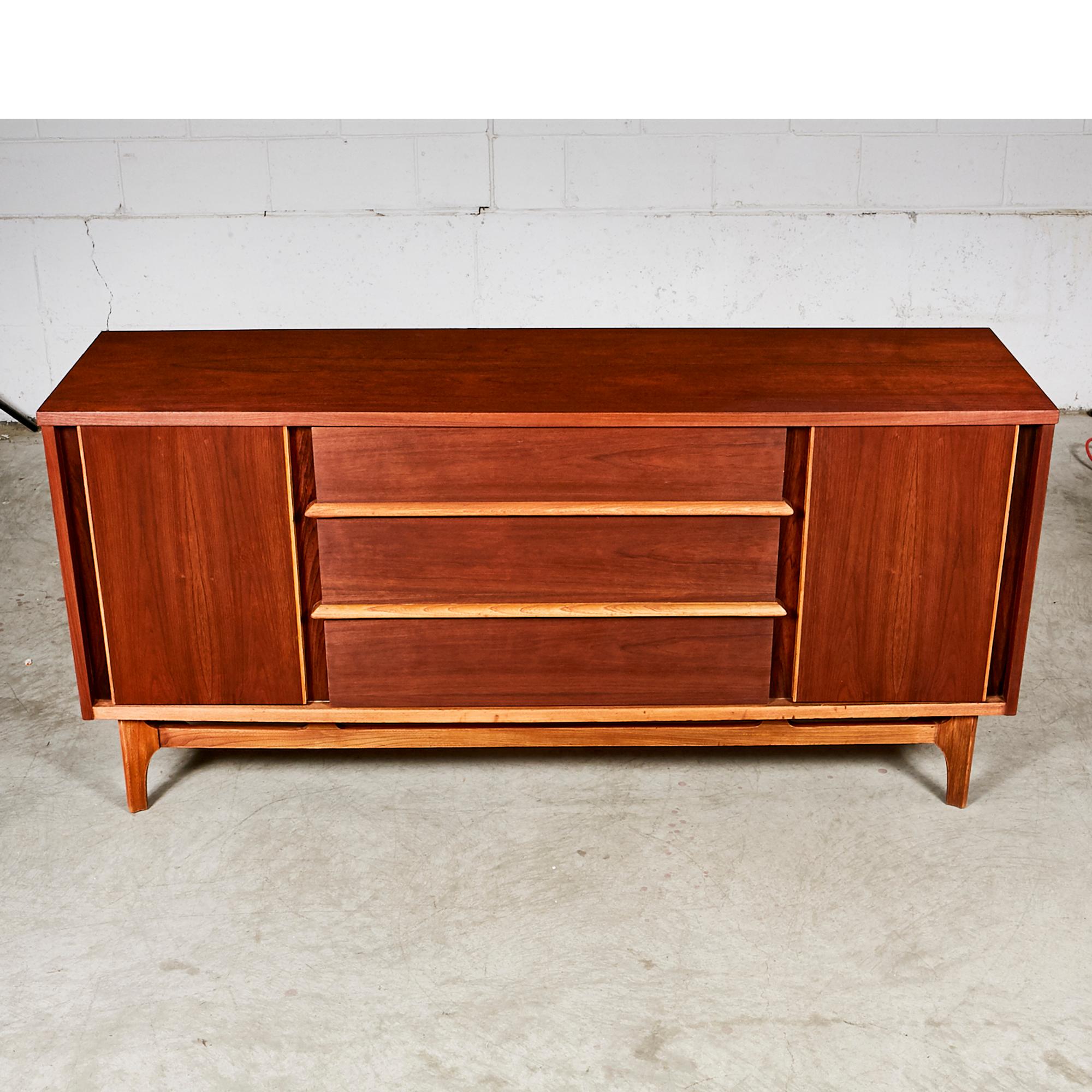 Mid-Century Modern 1960s walnut wood sideboard with contrasting ash wood accents. The sideboard has three drawers and shelving for storage. In newly refinished condition. No maker's mark.