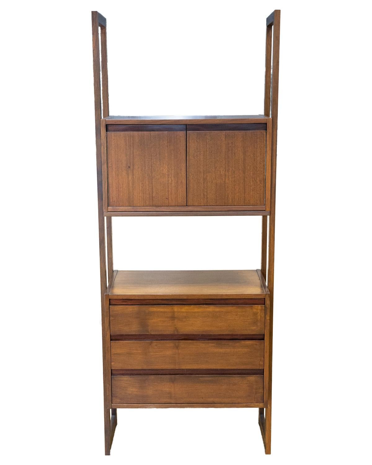 An elegant Mid-Century Modern walnut wall unit, cabinet is also a drop down desk. This piece is in very good vintage condition. It consists of three sections, each with shelving and cabinets. Fully assembled, this wall unit measures 74.5 in high, 86