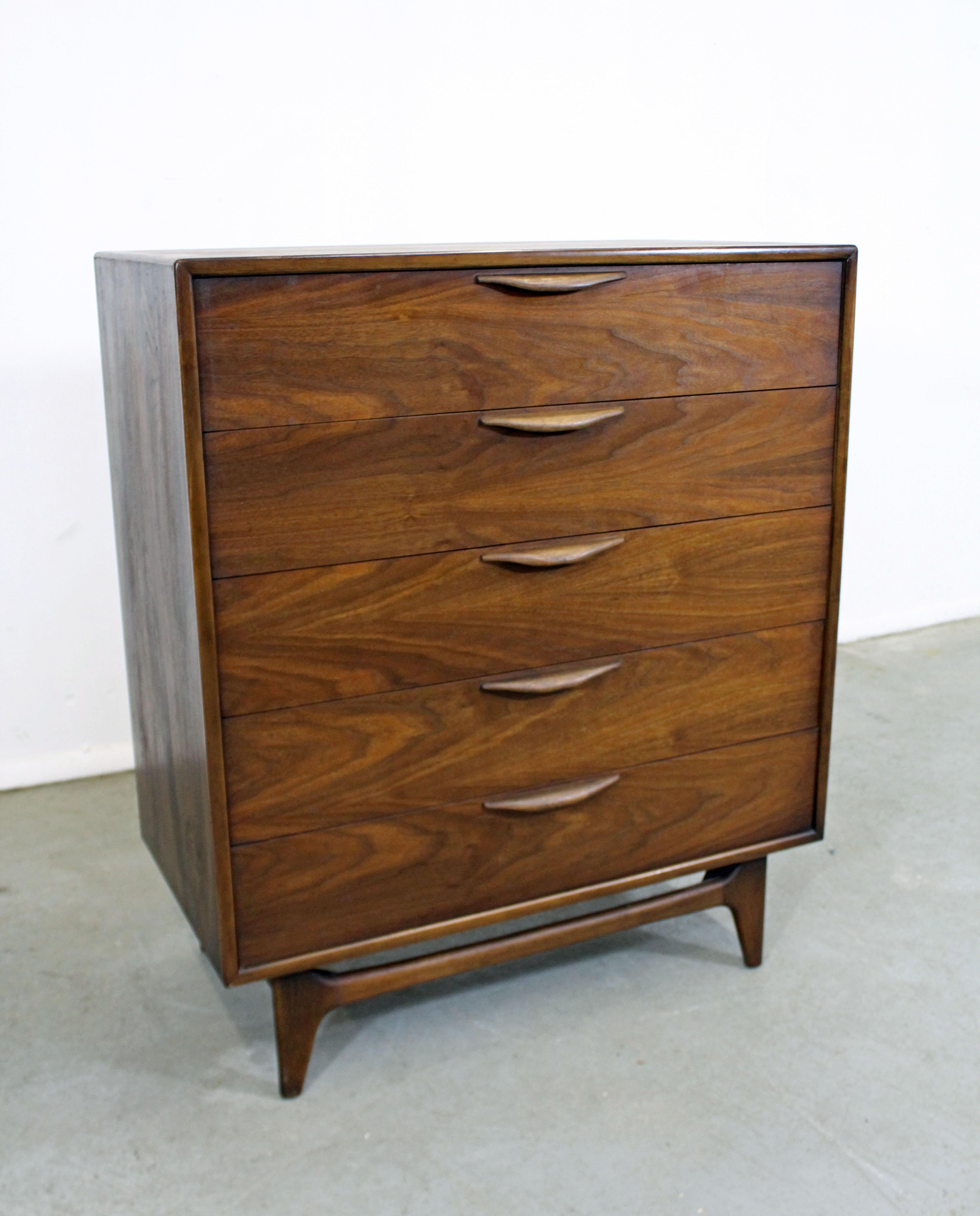Offered is an excellent example of American Mid-Century Modern design, a walnut tall chest designed by Warren Church for Lane Furniture's 'Perception' line. Features 5 dovetailed drawers with sculpted pulls. It is in excellent condition for its age,