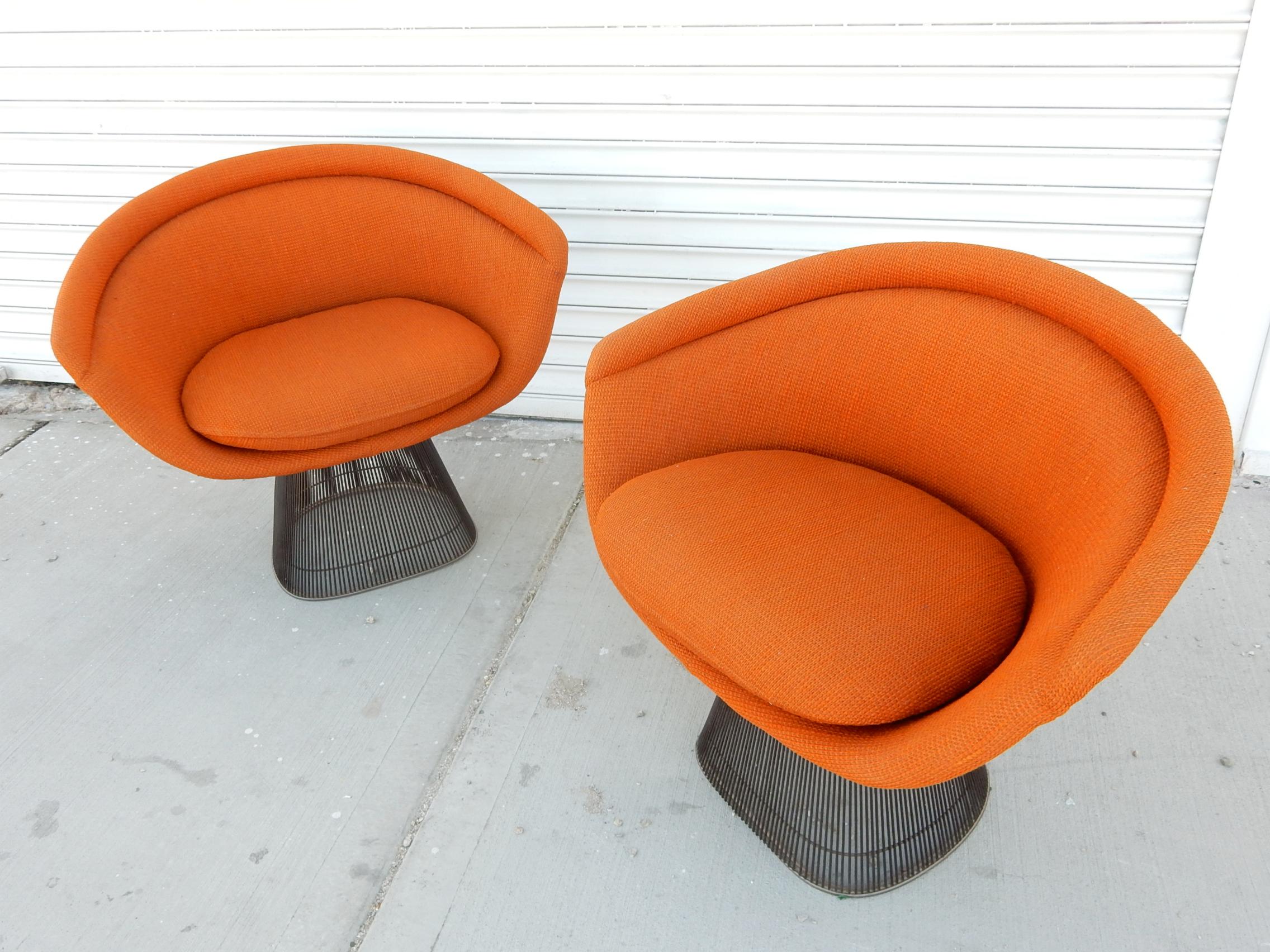 Extraordinary pair of the iconic wire lounge chair designed by Warren Platner for Knoll International., dated 1978.
Original Knoll orange upholstery on anodized black wire frames. Both labelled under seat cushion.
These chairs are clean and show