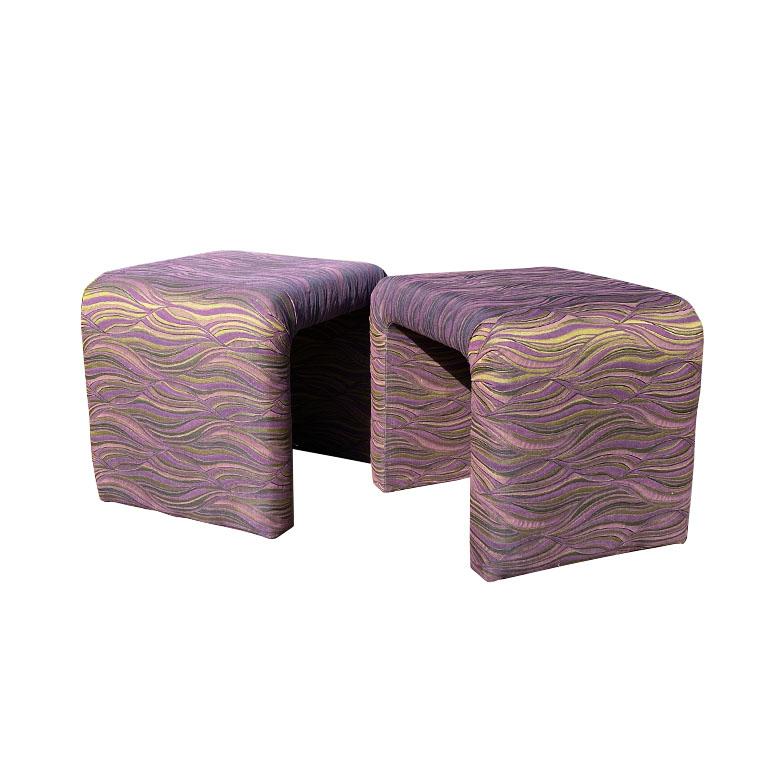 A pair of two purple flame stitch waterfall edge ottomans or stools after Milo Baughman. Baughman's timeless designs have become a mainstay in the home of any mid-century design lover. From his Boldido chair and ottoman to his Archie lounge chairs,