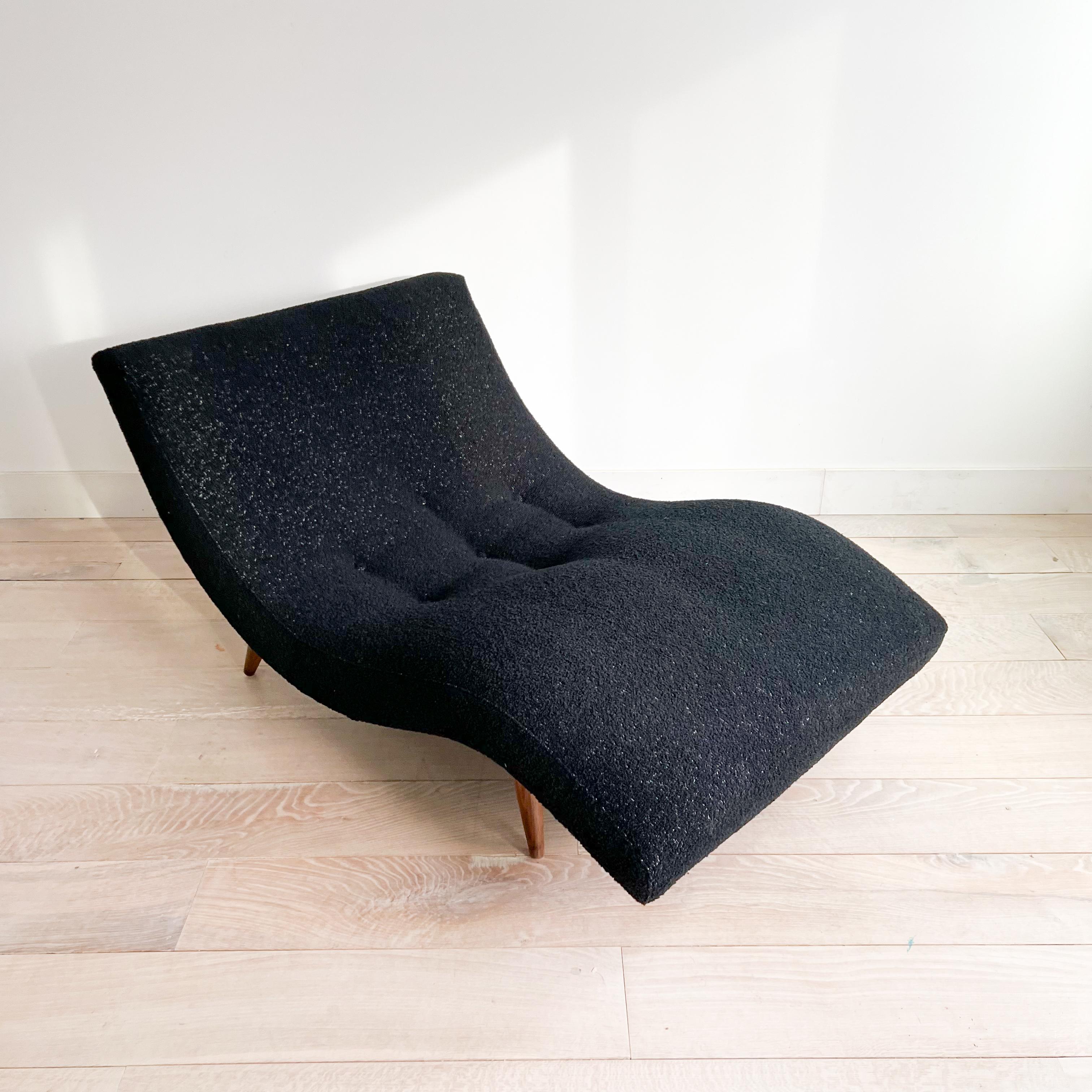  Elevate your relaxation experience with this iconic mid-century modern wave chaise lounge, featuring a sleek design and new textured black upholstery. Perfect for lounging in style, this chaise is a must-have addition to any contemporary living