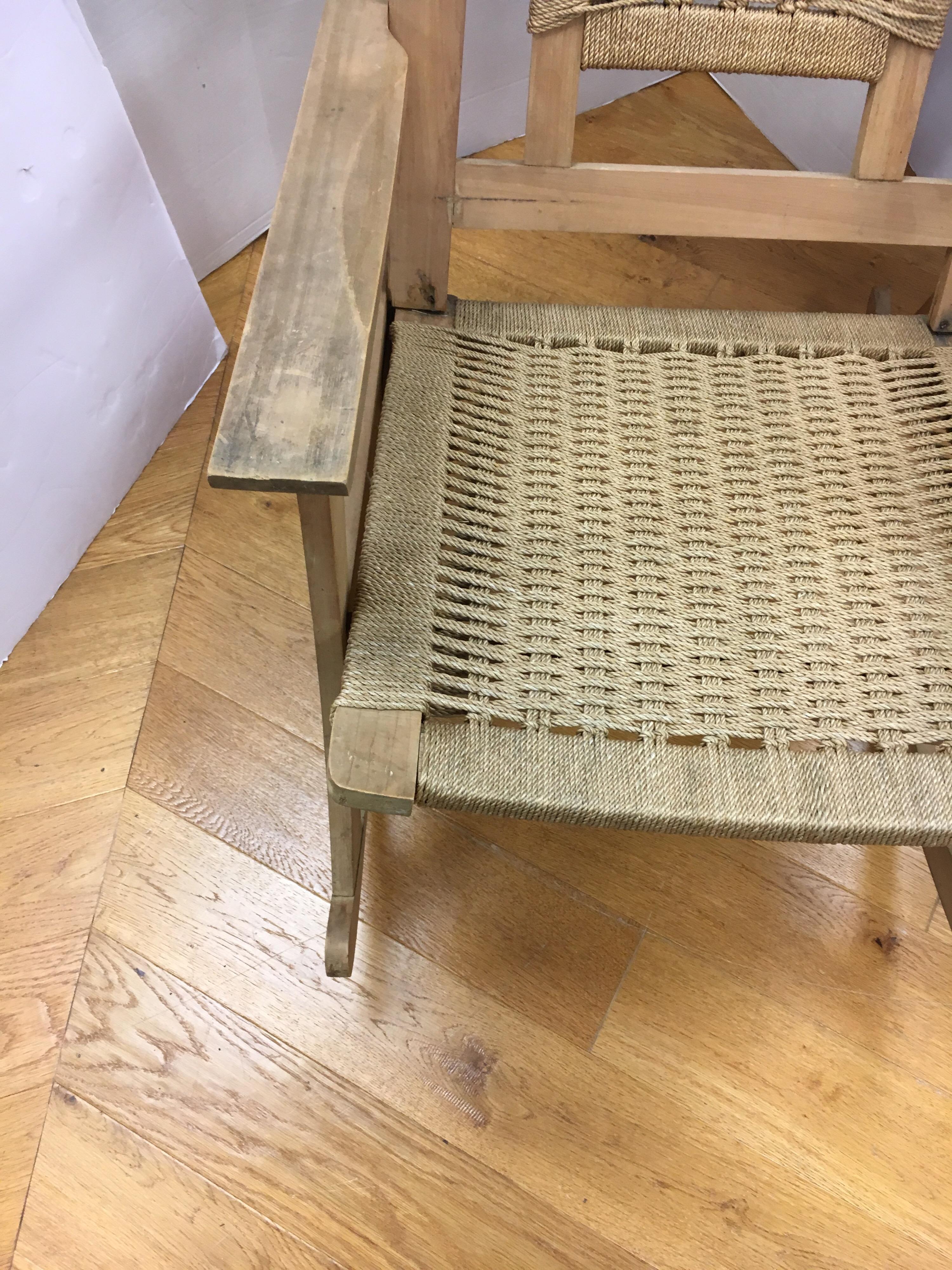 Vintage rocker with woven seats and back make a beautiful Mid-Century Modern addition to your home. Handmade rope seats, great scale, and Danish modern style add to the appeal of the piece.