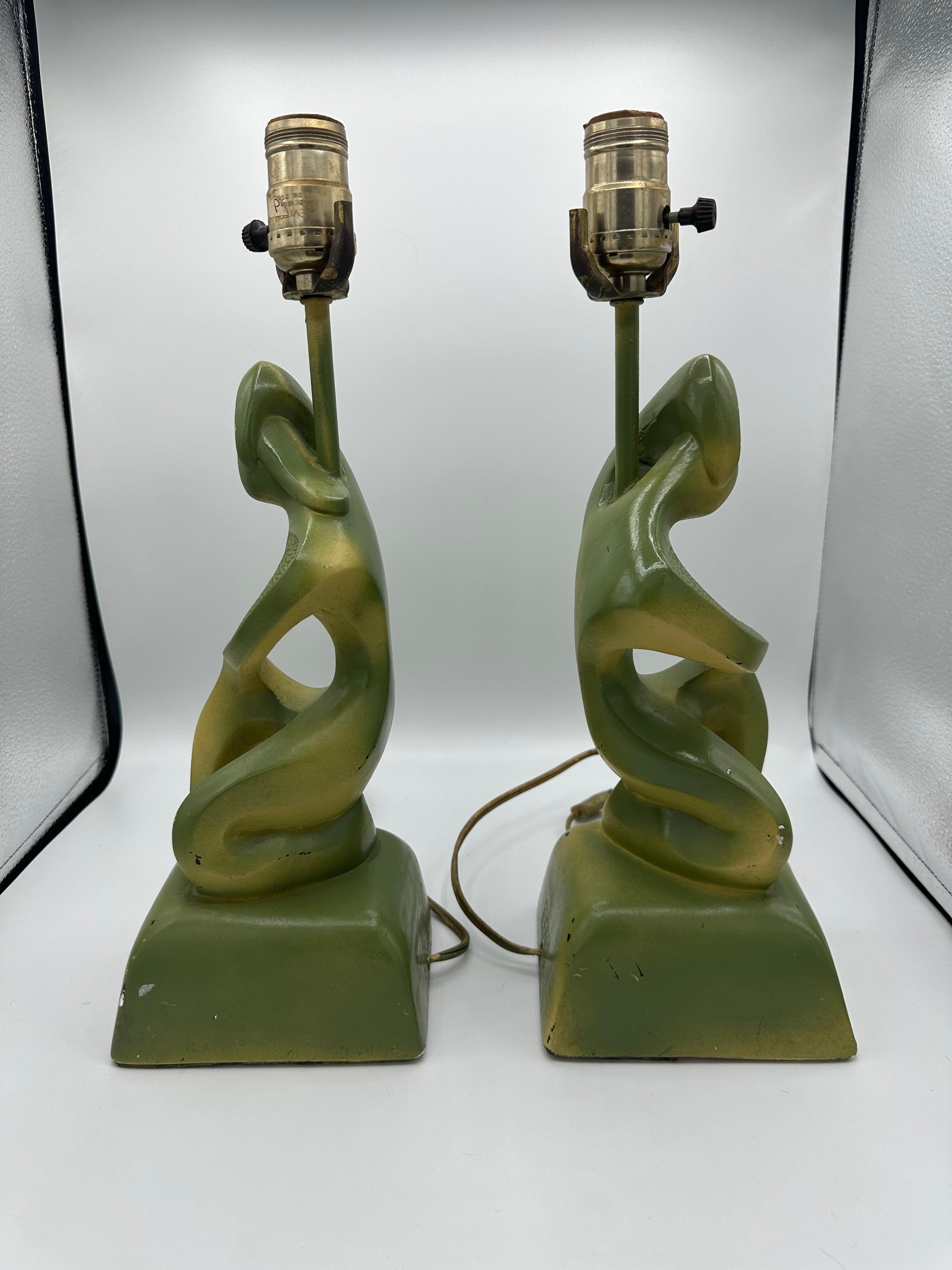 Mid Century Modern pair of Frederic Weinberg style table lamps. Signed on the back by FAIP (Fine Art In Plastic). Fun male and female abstract figural apposing designs in style of Frederic Weinberg. Good vintage condition with some paint touch ups