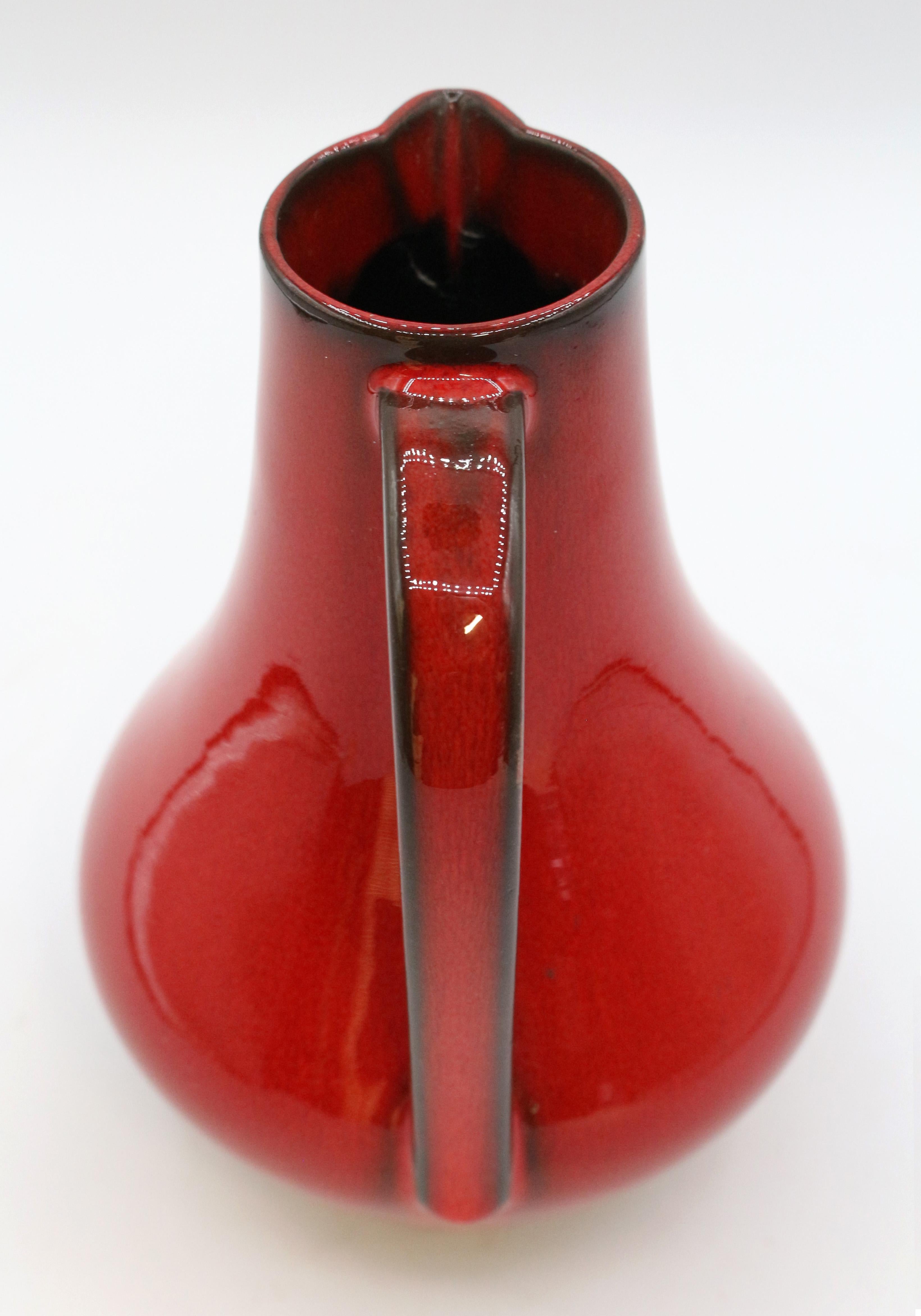 Mid century modern West German pottery pitcher. Red with brown. Maker's mark stamp & 