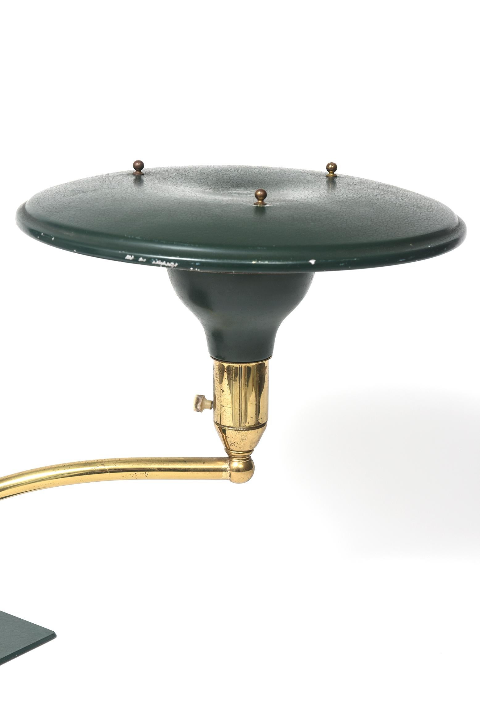 Mid-century wheeler sight light desk lamp Leroy Doane. This is a wonderful Sight Light desk lamp designed by Leroy C. Doane. This lamp reaches out on a brass stem that swivels and has a green metal shade. The base is substantial to support the