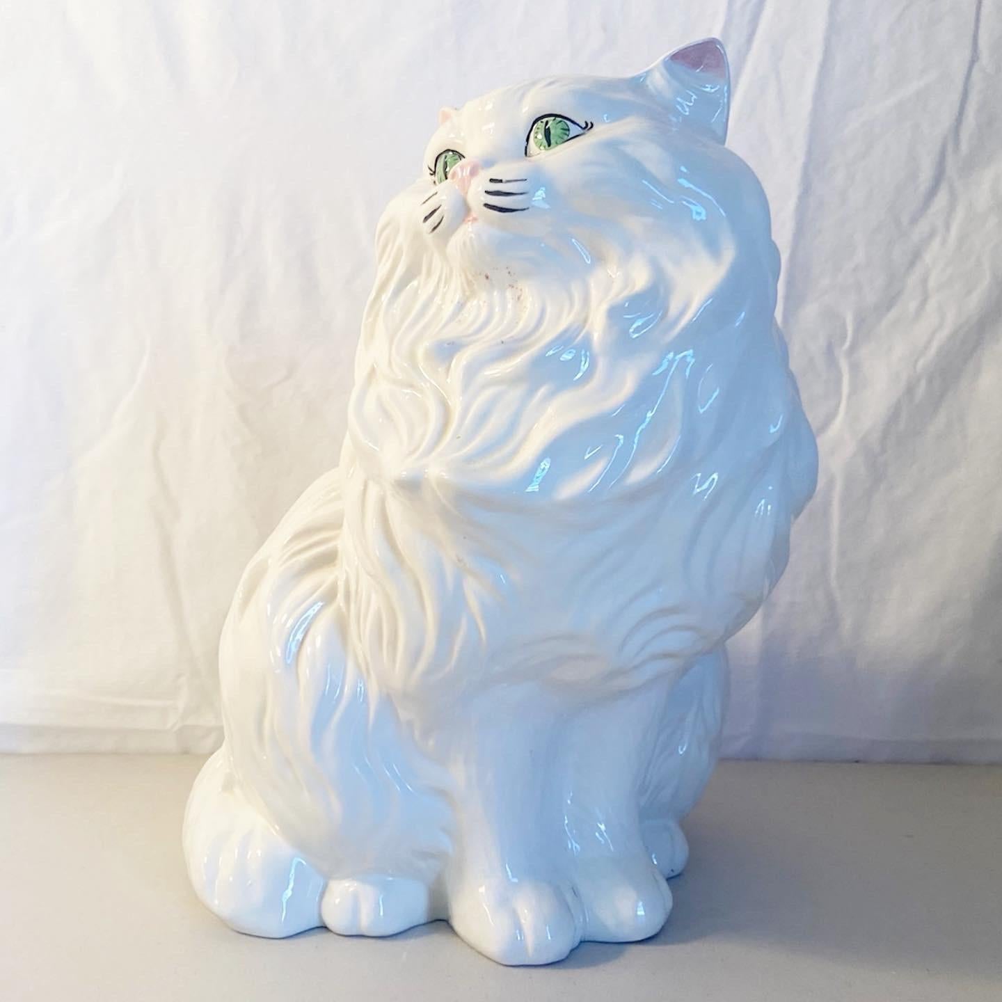 Exceptional Mid-Century Modern ceramic cat sculpture. Features a white finish with green eyes.
 