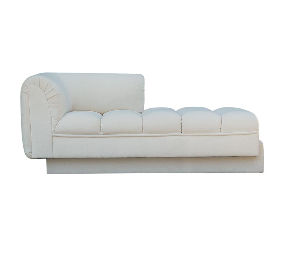 A stunning chaise lounge or loveseat with incredible design lines. This well built chaise is by Directional furniture, circa 1970s. It features a ribbed channel seating area with fine quality construction. Manufacturers tags. Original fabric is